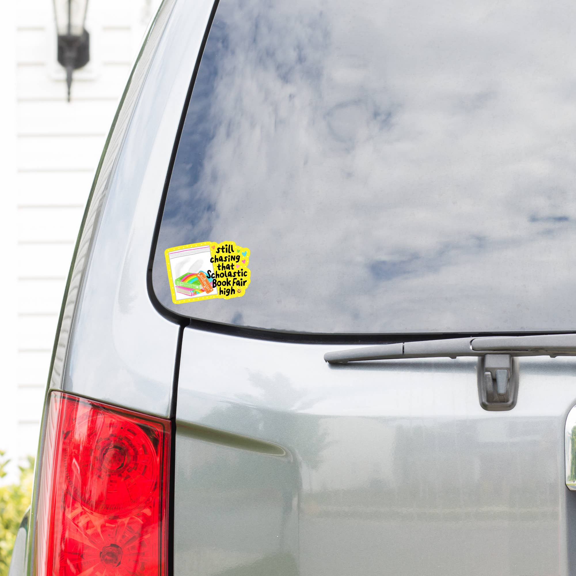 Sticker on a car window with text and rainbow design