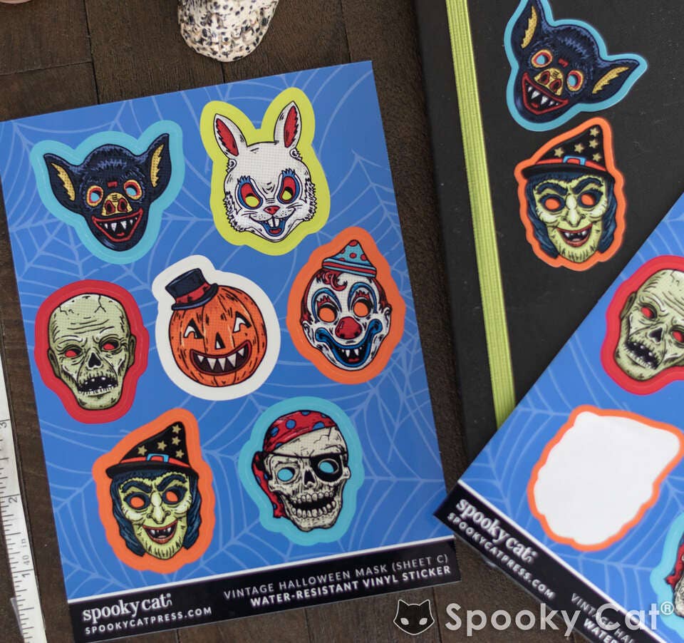 Halloween-themed stickers on a blue sheet with &