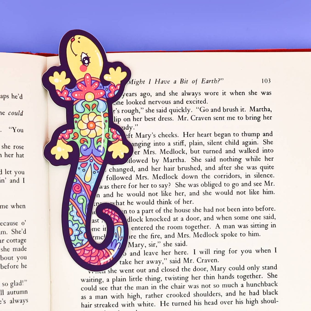 Colorful lizard-shaped bookmark on an open book