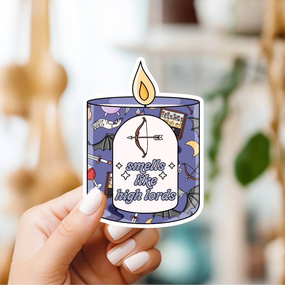 Sticker of a candle with decorative elements and text held by a hand.
