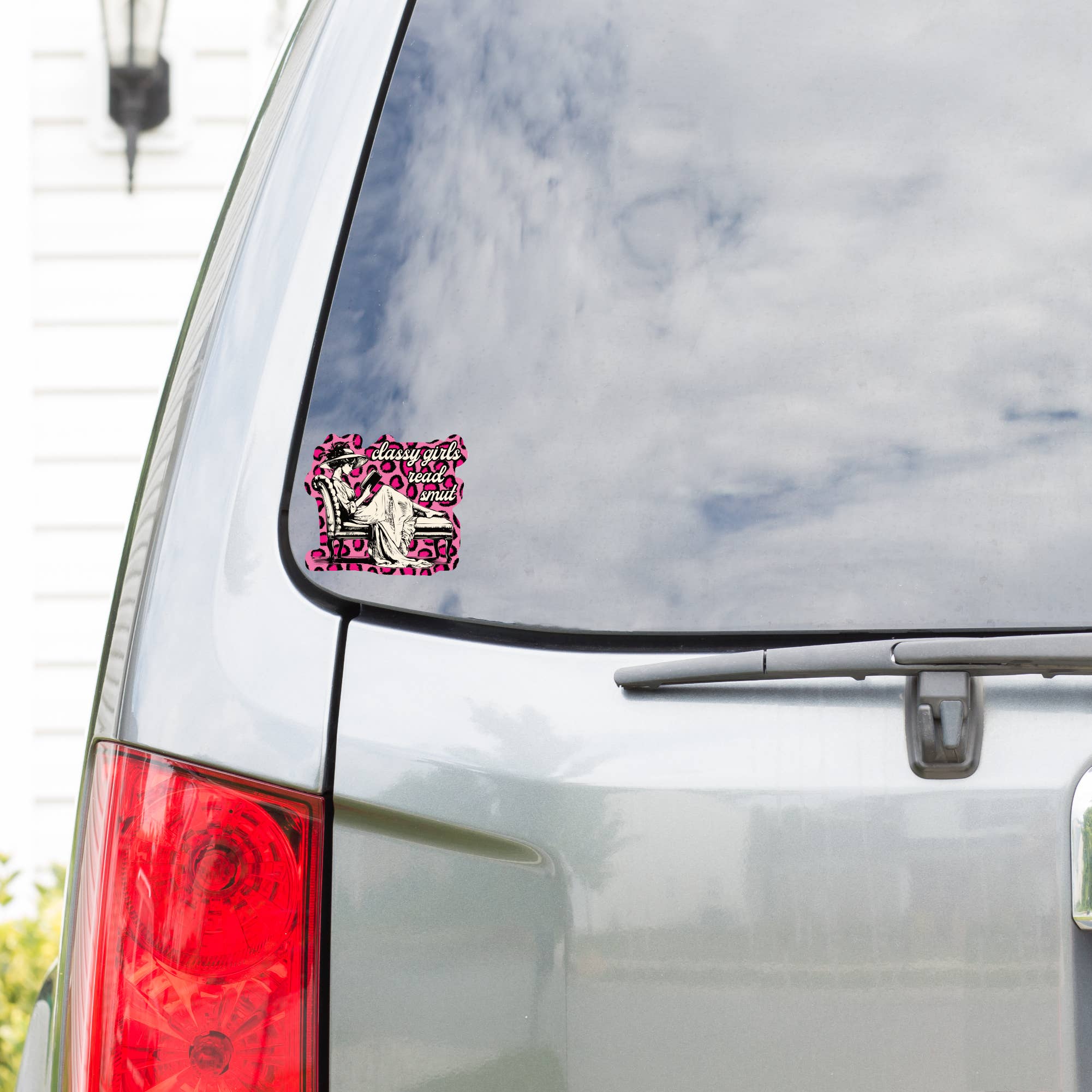 Car with a pink and black decal on the rear window