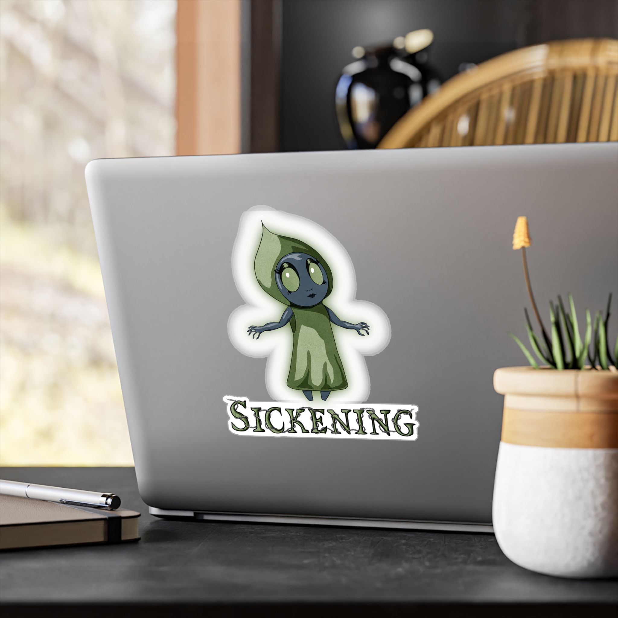 Large Flatwoods Monster cryptid sticker on the back of a silver laptop