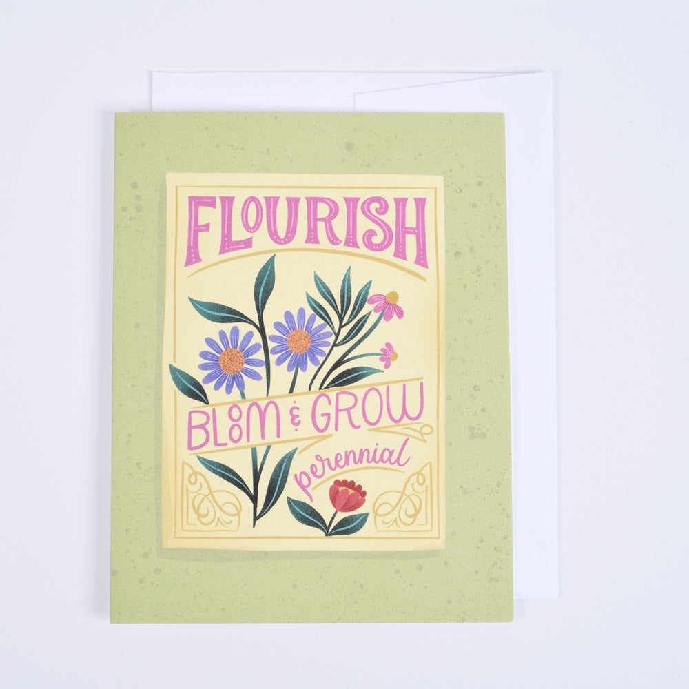 A folded greeting card with a colorful floral design and the words &