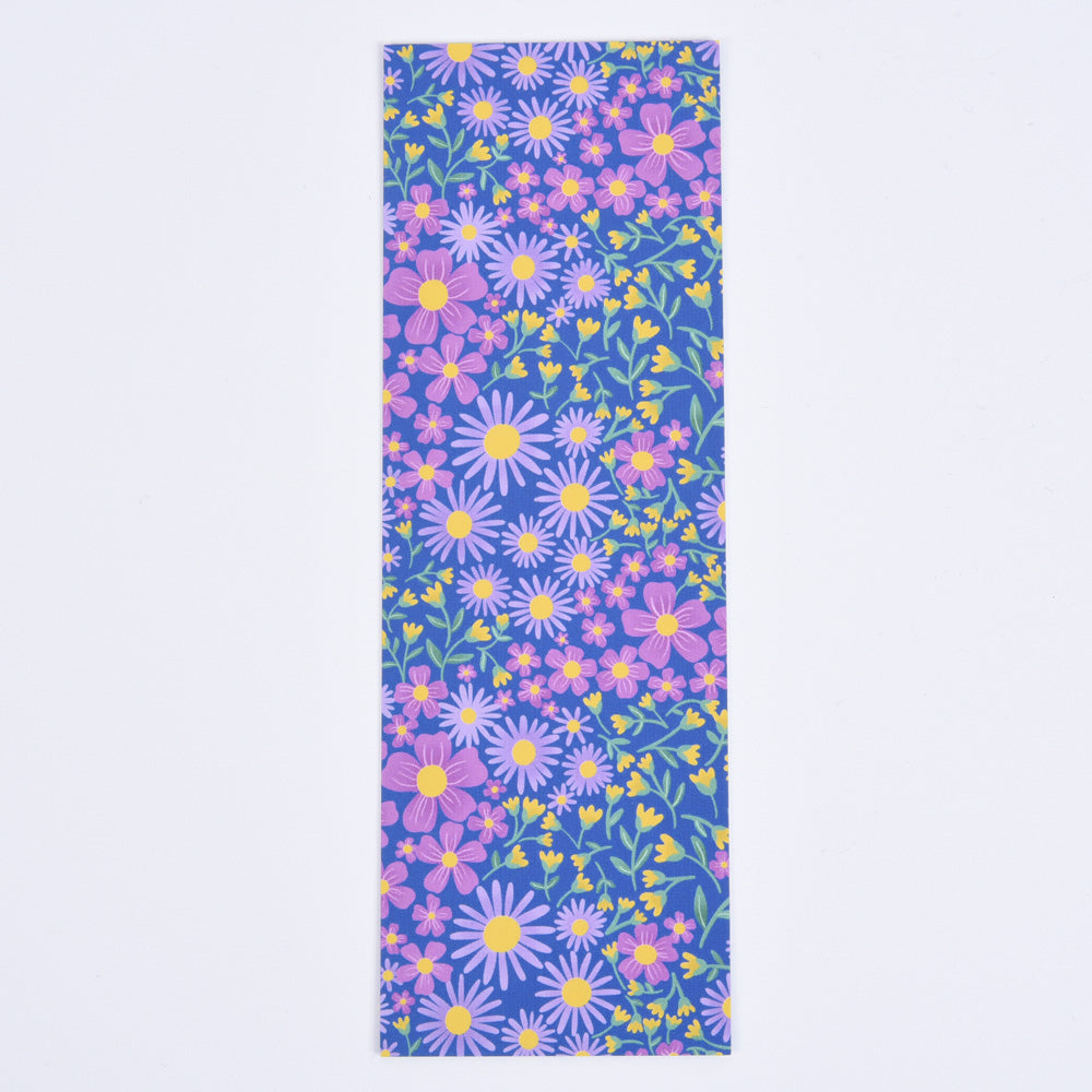 A bookmark with a floral pattern featuring blue and purple flowers on a blue background.