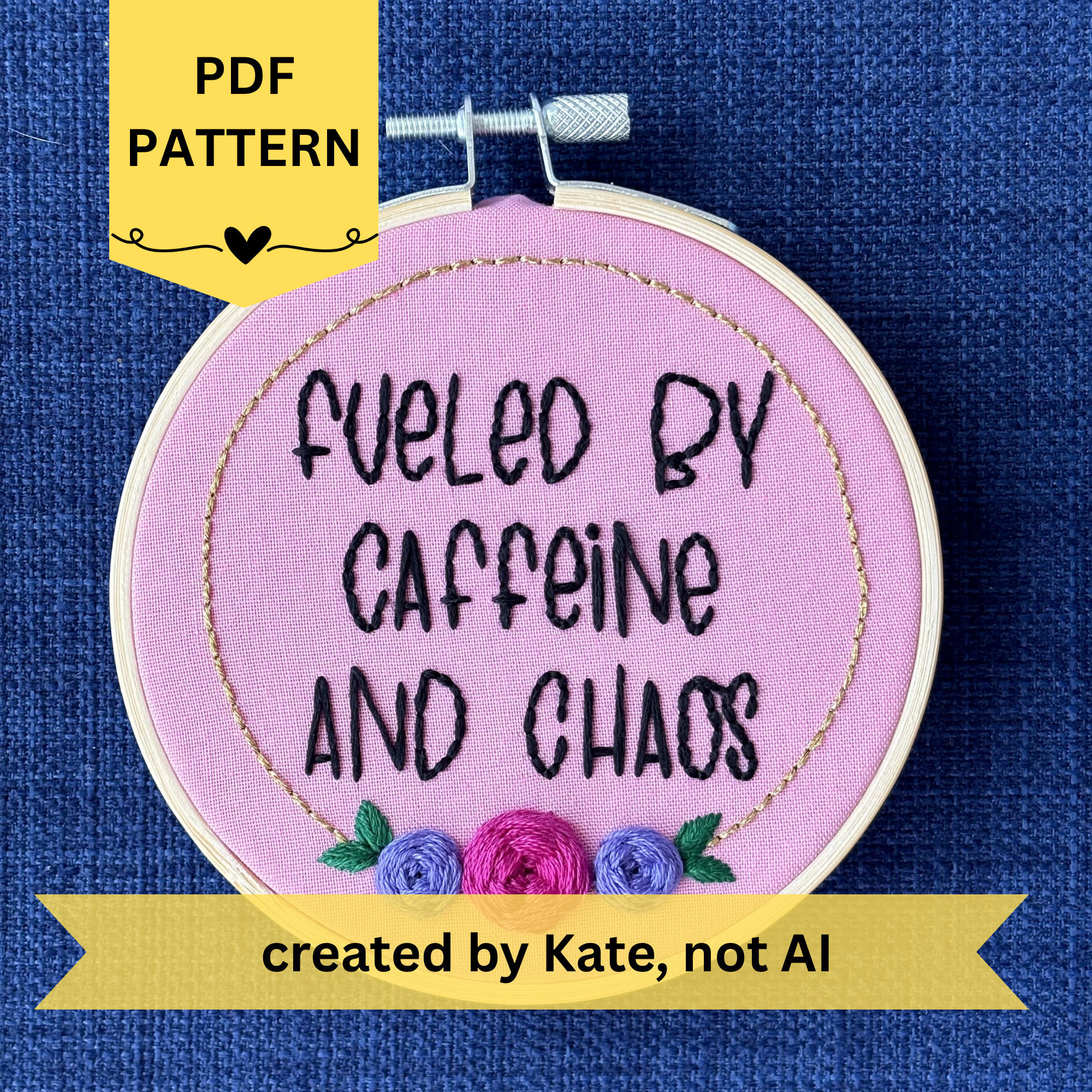 PDF pattern created by Kate, not AI. Finished embroidery reads, "fueled by caffeine and chaos". Quote in handwriting print font and hand embroidered in black. Words are centered in a floral frame, which is metallic gold and embellished with cheerful pink and purple roses and dark green leaves sewn with embroidery thread. Fabric is pink cotton. Framed in light wood embroidery hoop as wall art.