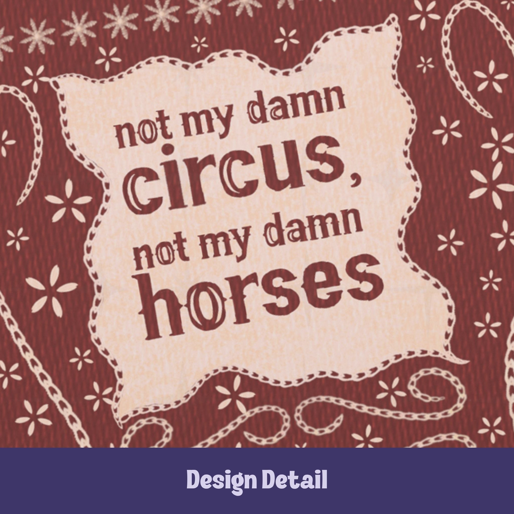 Close-up of hand-lettered text reading not my damn circus not my damn horses on cream cartouche with stitched embroidery border detail on burgundy journal cover