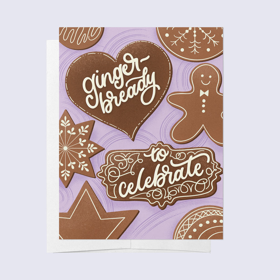 A greeting card with a gingerbread theme, featuring cookies, a gingerbread man, and the text &