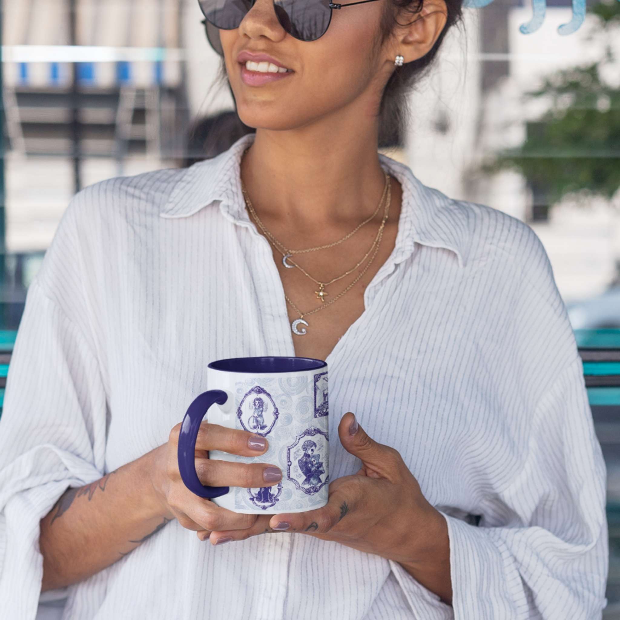 Person holding a blue and white delft zombie portrait gallery mug with navy handle