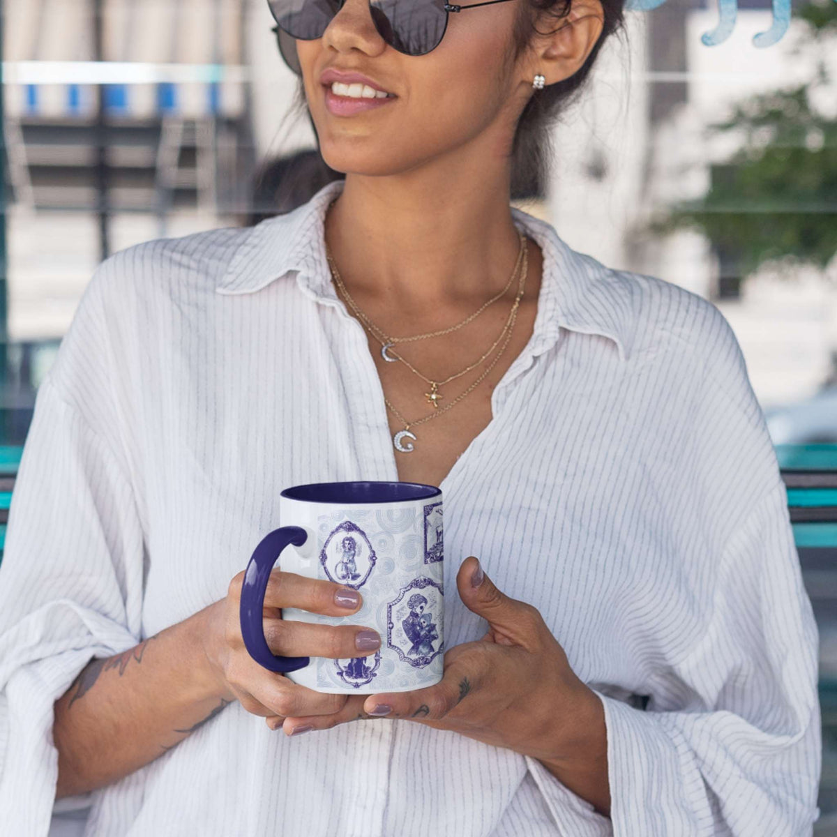 Person holding a blue and white delft zombie portrait gallery mug with navy handle