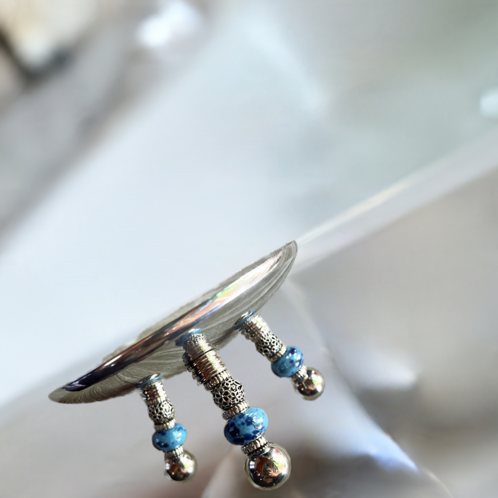 Elegant Blue Beaded Stainless Steel Candle Holder with Silver Dish - Perfect Romantic Gift in a cozy home setting.