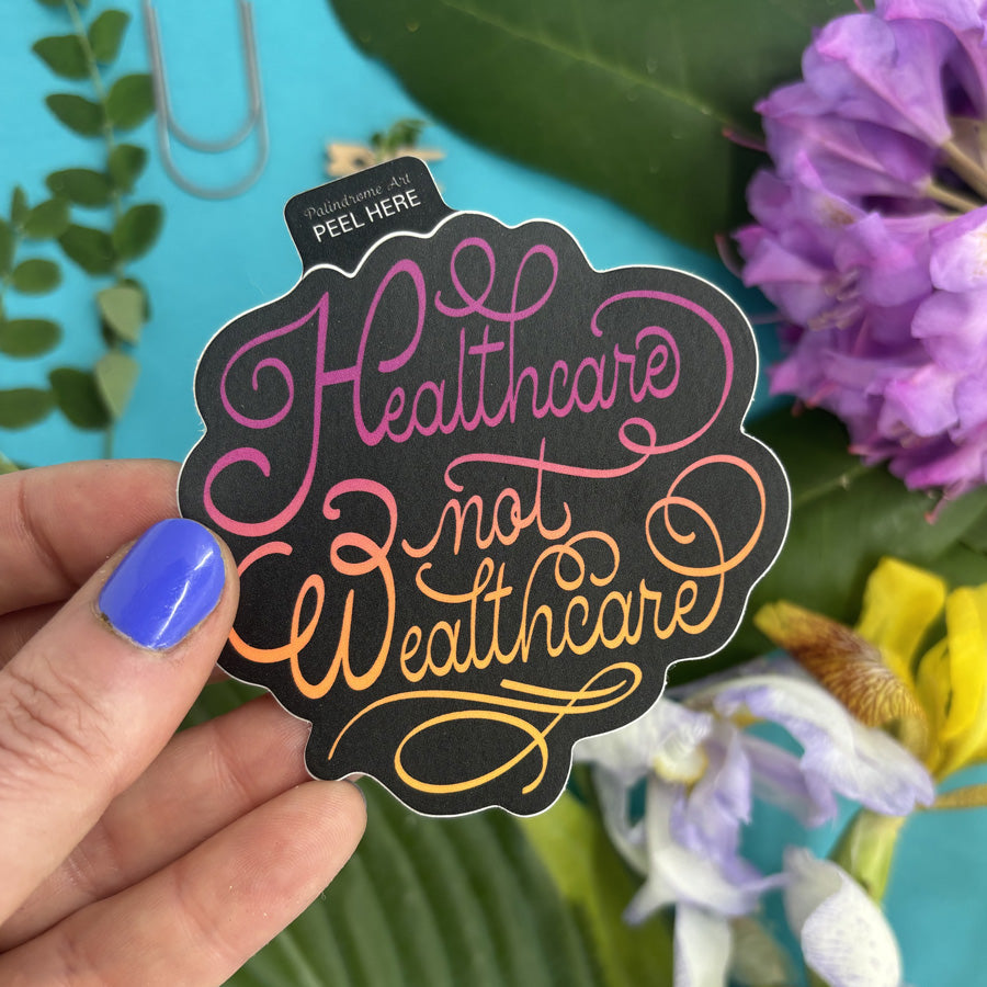 Hand holding a sticker with &
