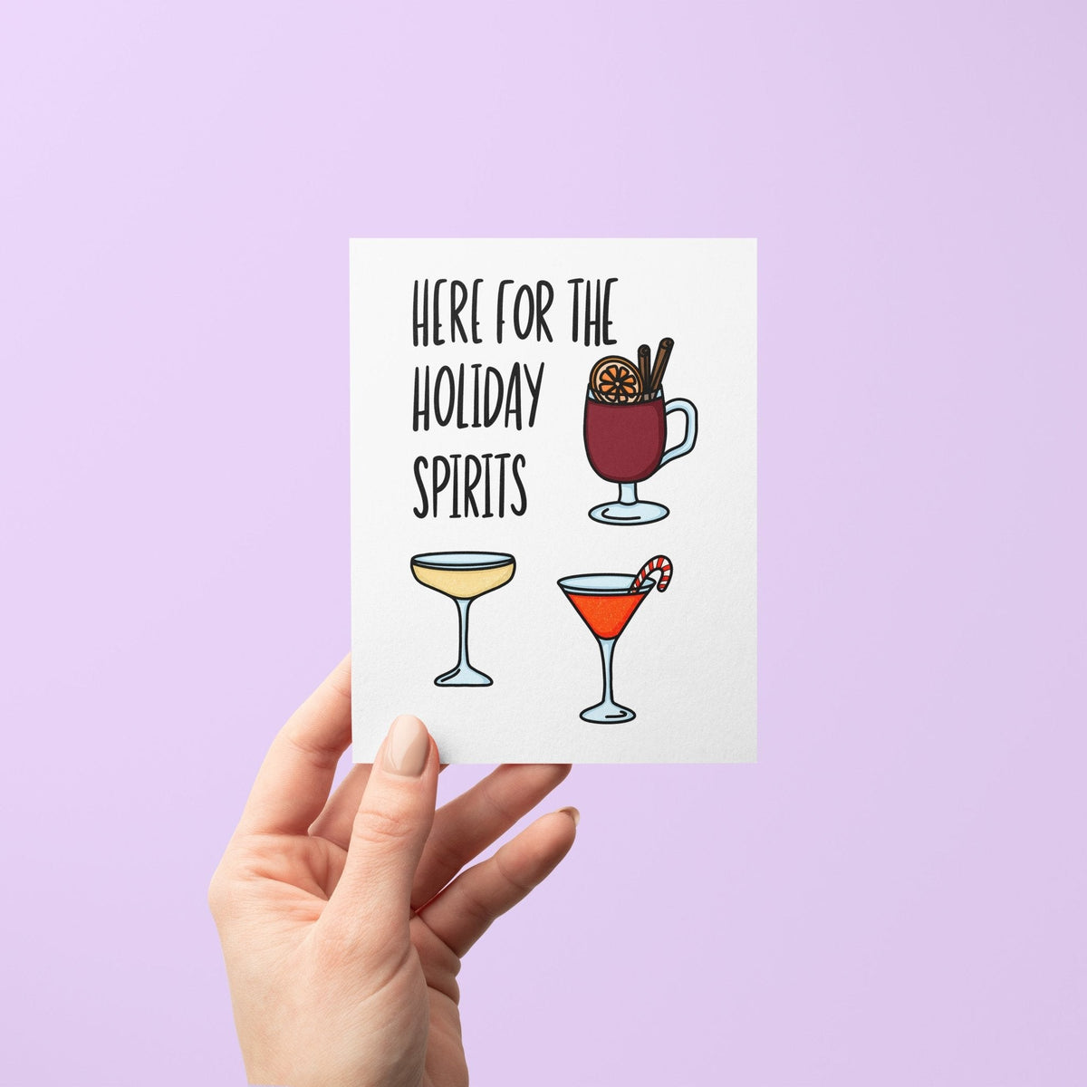 Here For the Holiday Spirits card flat lay — funny holiday cocktail card for party hosts by indie artist MangoIllustrated