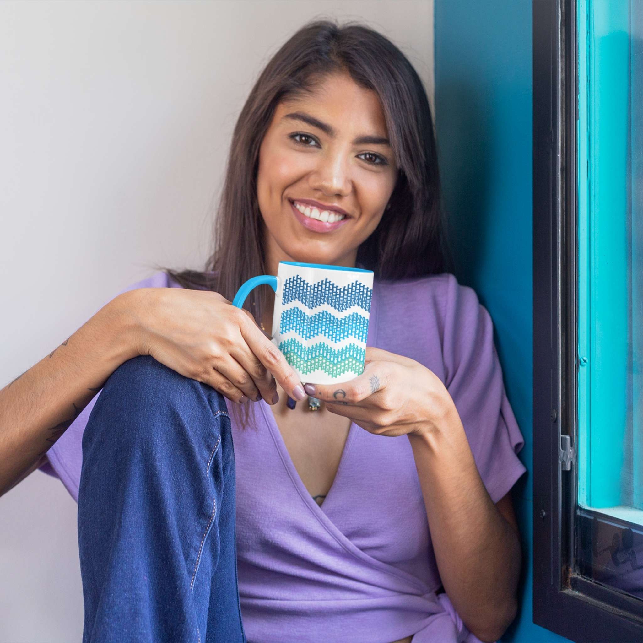 Woman holding ocean gradient hidden profanity accent mug with blue handle near window with teal frame