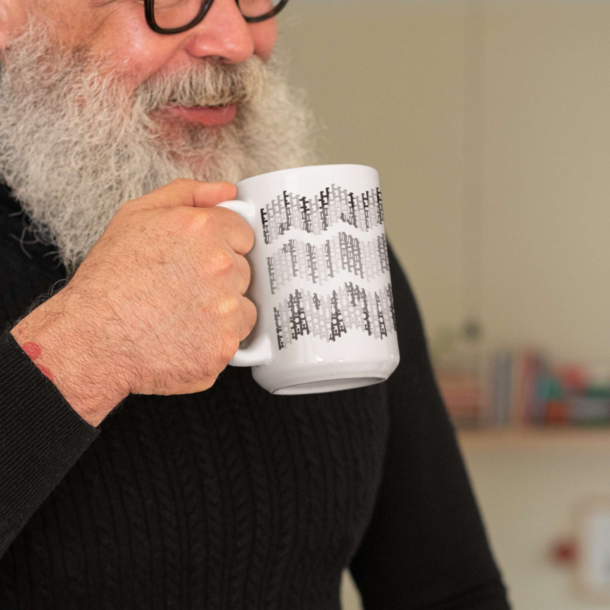 Man in black sweater holding 11oz hidden profanity mug with gray chevron swear word pattern