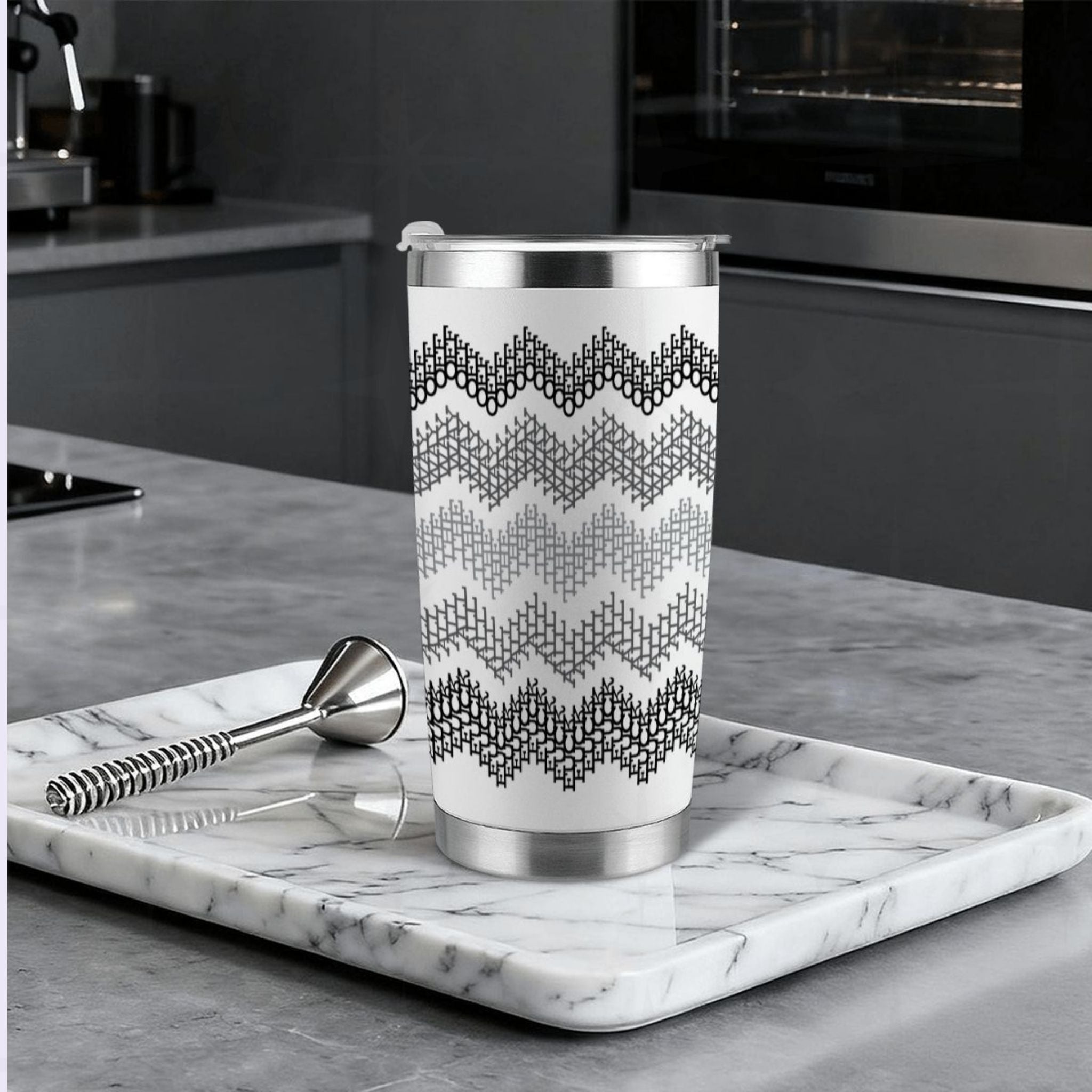 Gray stripe hidden profanity tumbler on marble tray in modern kitchen with cocktail bar spoon and stainless steel straw