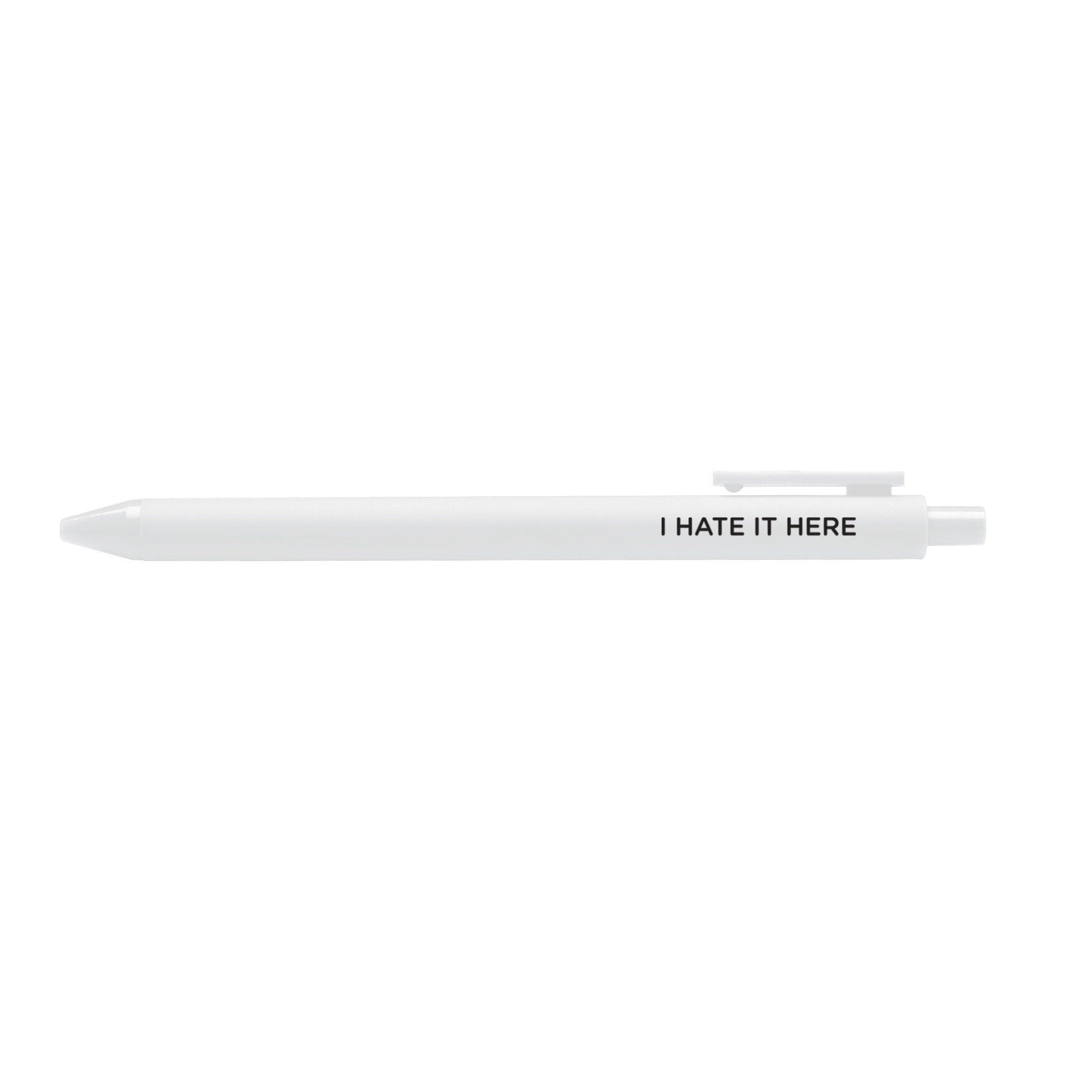 I hate it here pen flat lay — white barrel funny relatable desk pen by indie artist MangoIllustrated