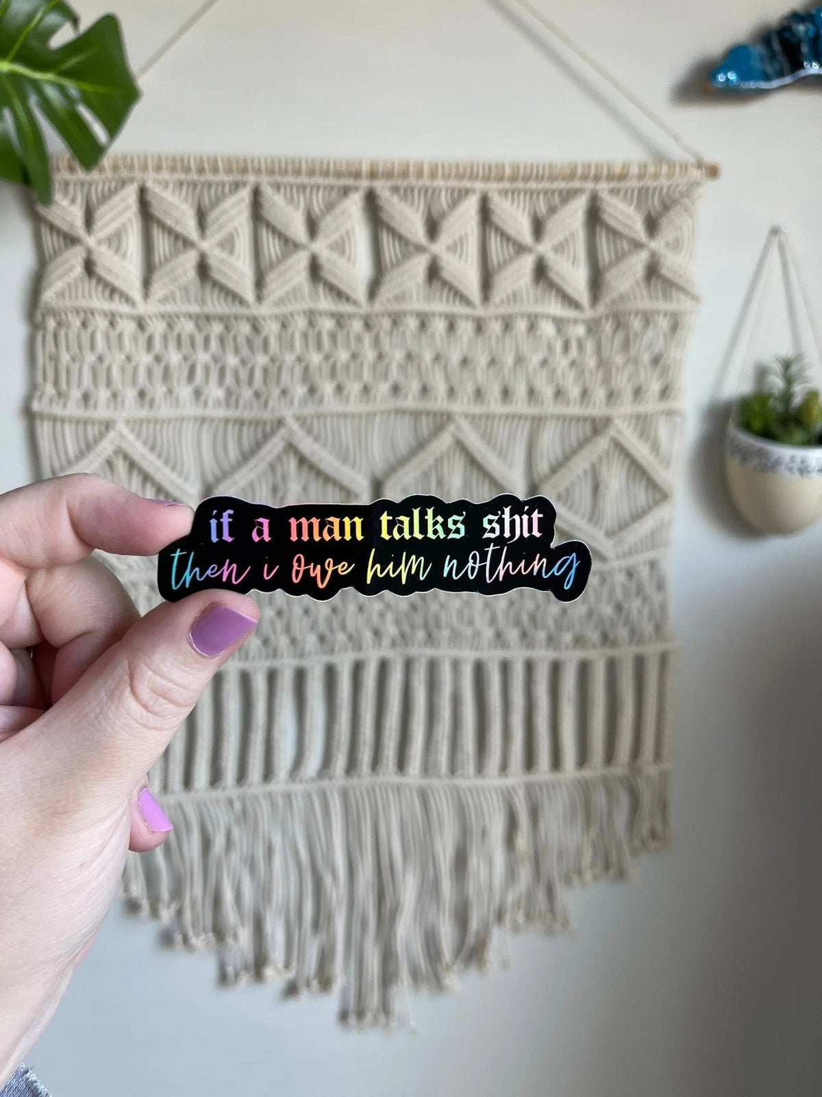 If a man talks shit then I owe him nothing holographic sticker flat lay — feminist holographic laptop sticker by indie artist MangoIllustrated