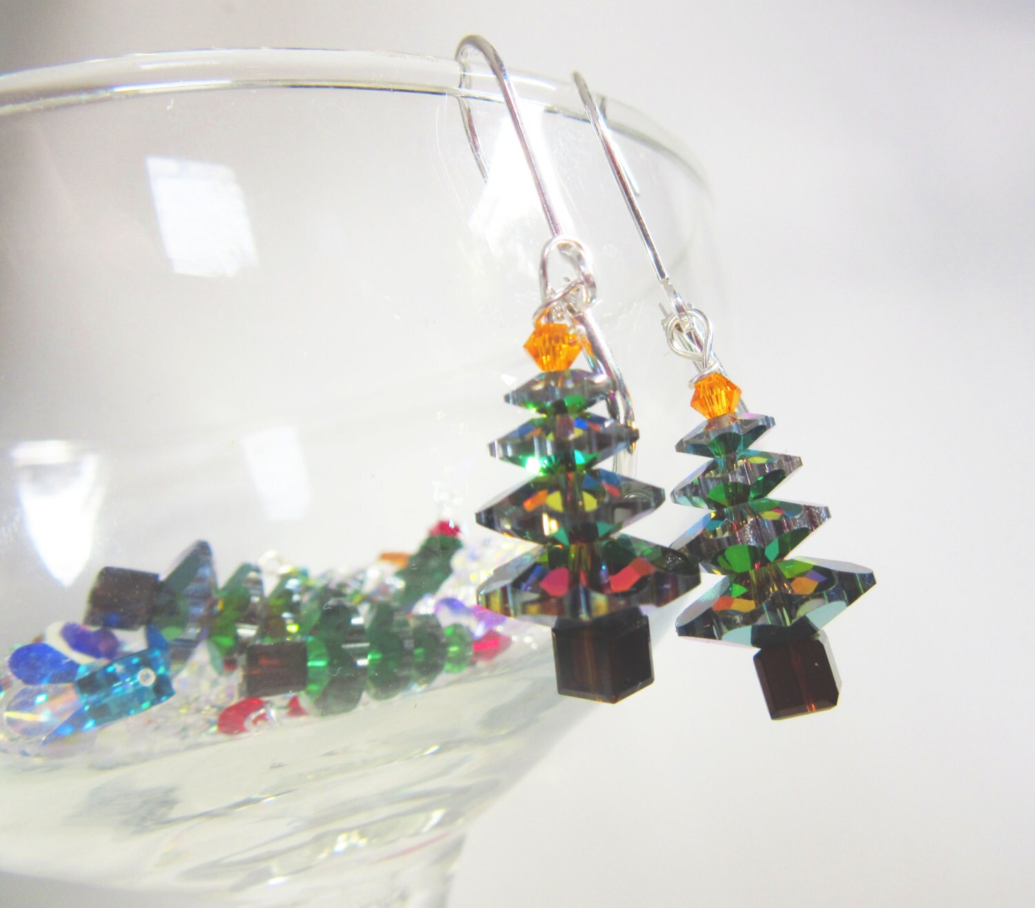 Deep Blue Shimmery Christmas Earrings crystal sparkle - Xmas jewelry - dangle earrings displayed on a festive background.