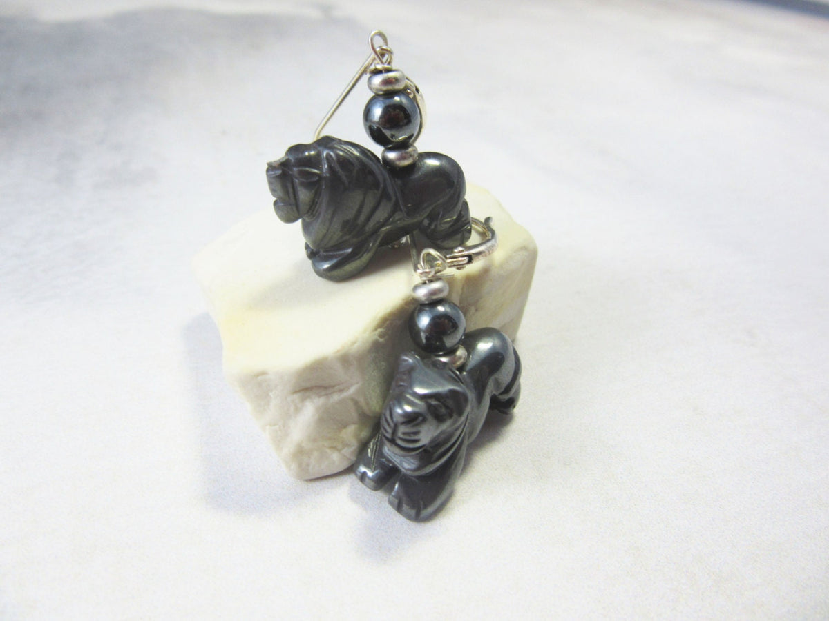 Close-up of Carved Hematite Lion Earrings, highlighting their unique animal-themed design, a perfect gift for a mammologist or anyone who loves wildlife.