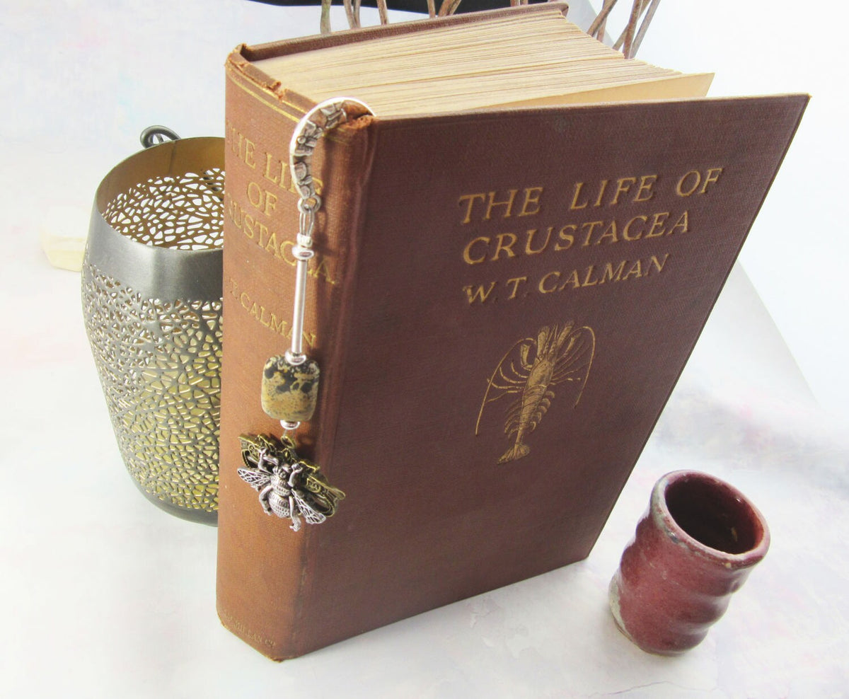 Honeybee bookmark with floral silver base and bronze bee, highlighting the unique design for enthusiasts of beekeeping and honeybees.
