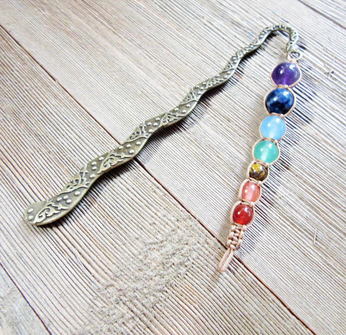 Chakra metal bookmark - intricate design showcasing 7 chakra beads, perfect gift for book lovers and spiritual readers.