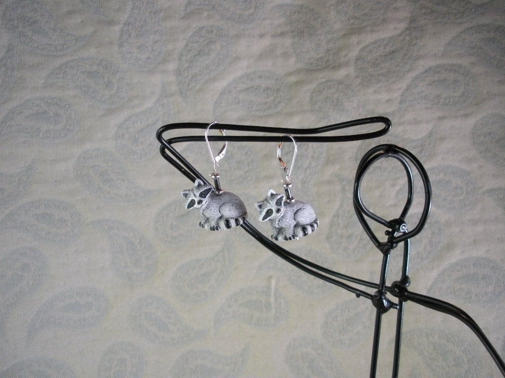 Raccoon earrings featuring hematite stone, handcrafted woodland animal jewelry for nature lovers, cute boho drop earrings.
