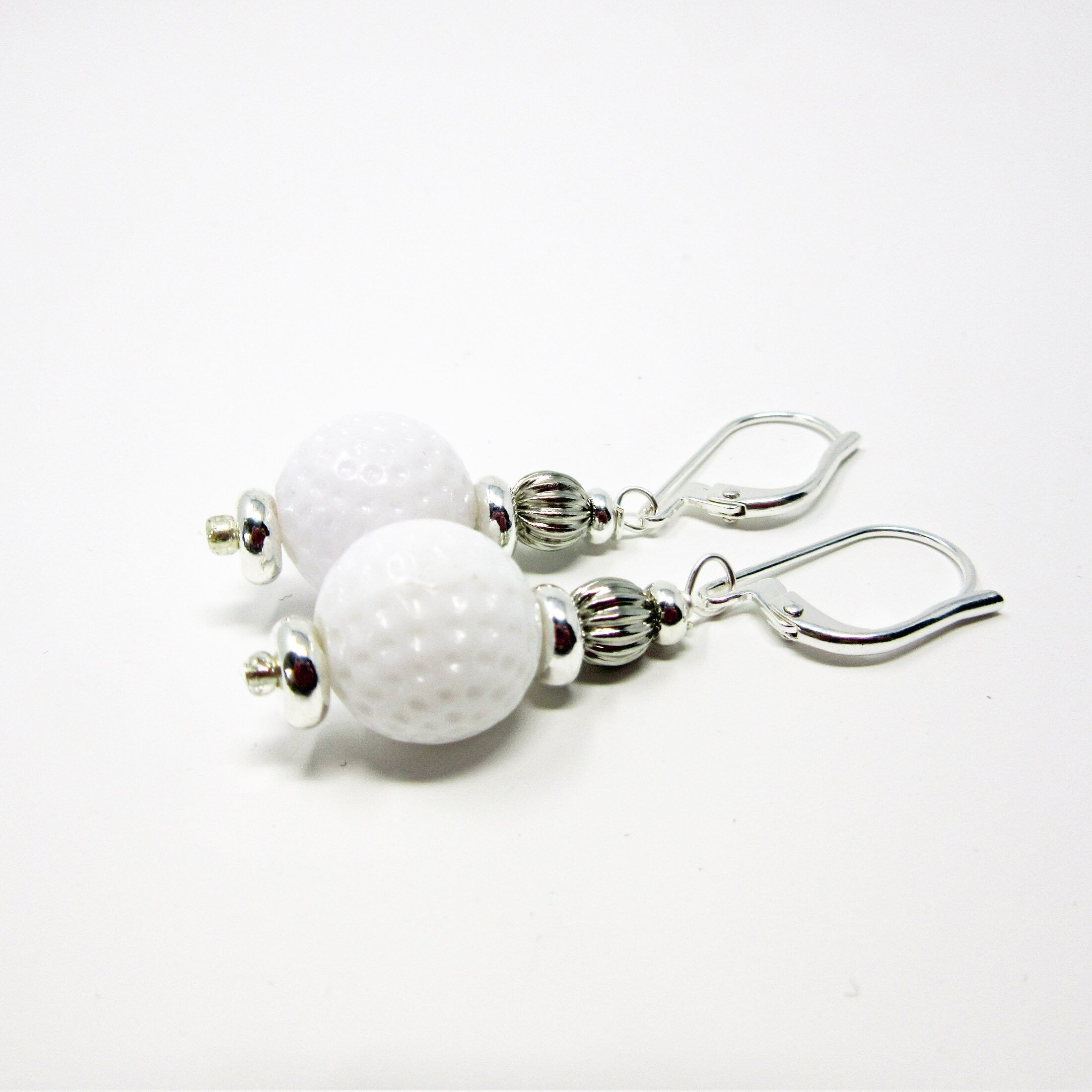 Golf Earrings a Gift for Woman Golfer set against a rustic backdrop, emphasizing the unique handmade quality.