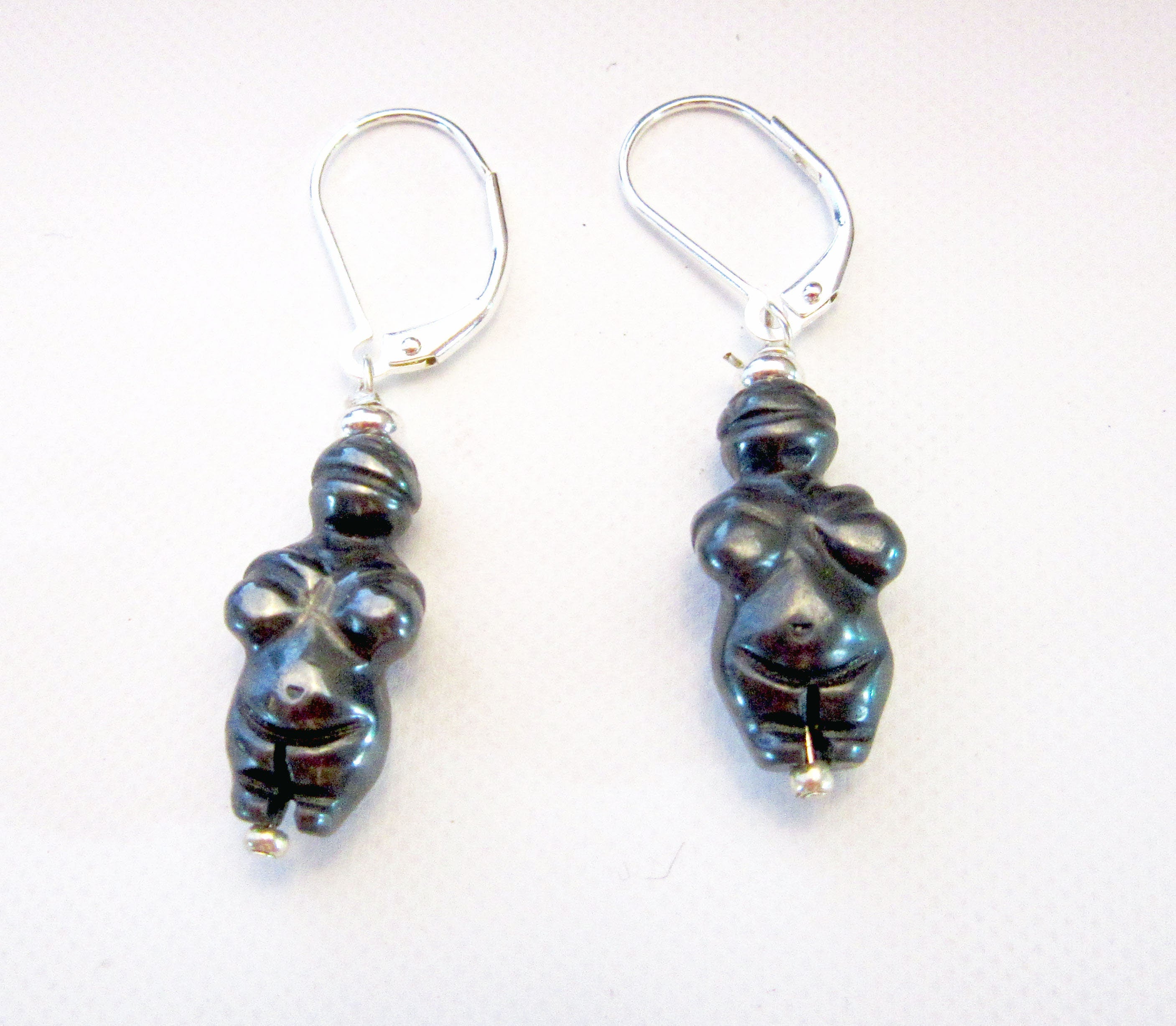 Close-up view of the Goddess earrings inspired by the Venus of Willendorf, showcasing the elegant carved sodalite and primitive style for an ancient soul.