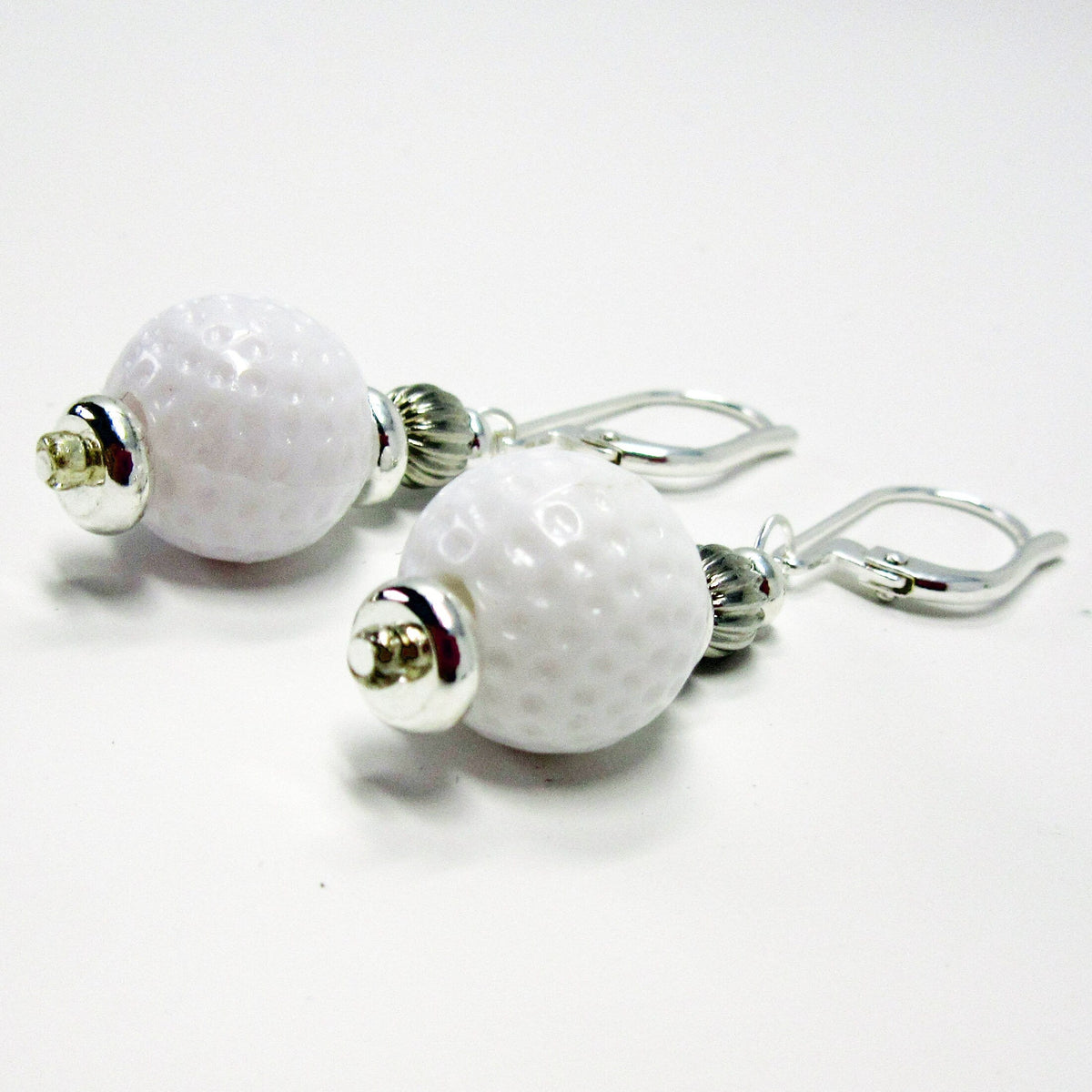 Golf Earrings a Gift for Woman Golfer worn by a person, perfect for any golf enthusiast.