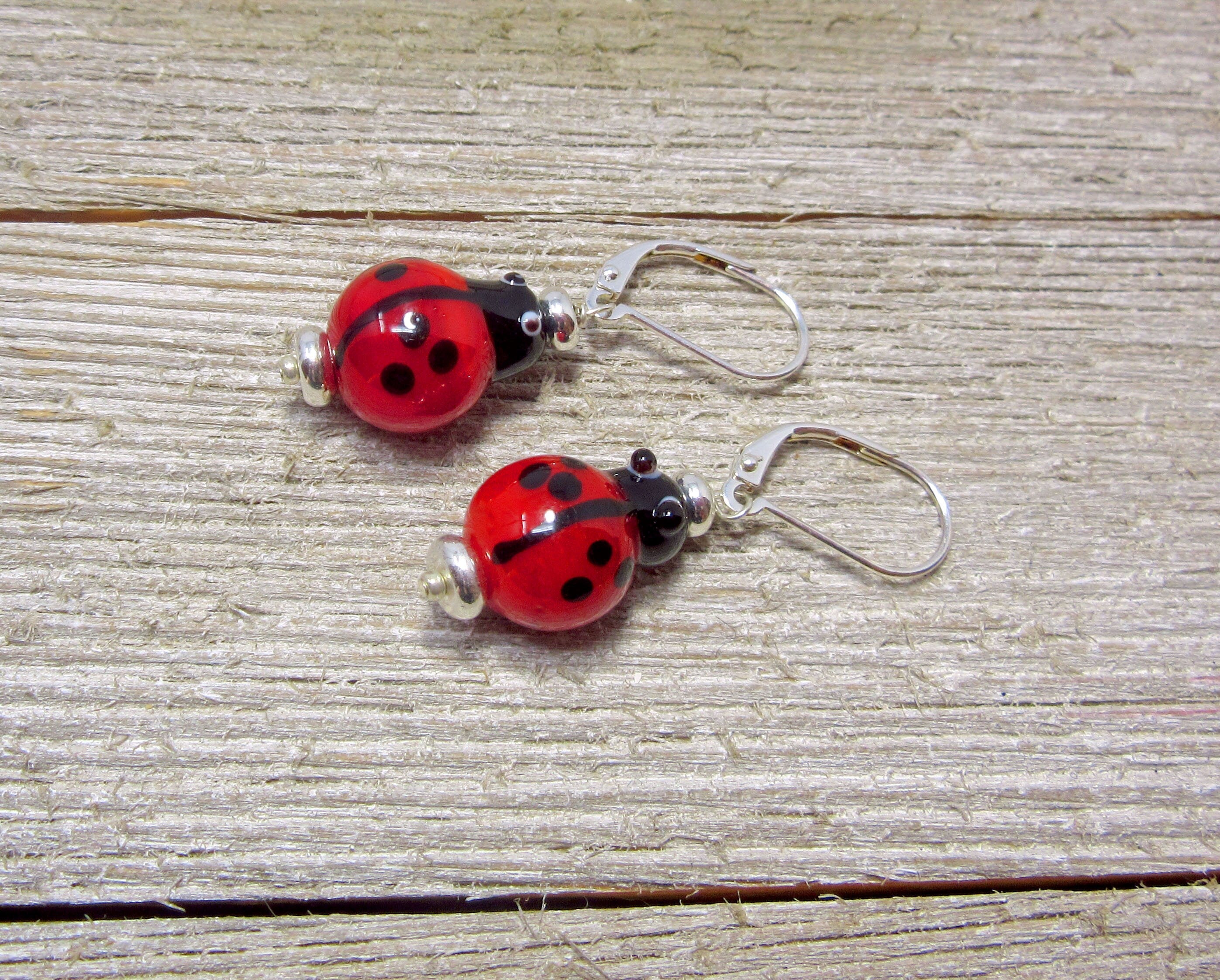 Ladybug earrings of Lampworked Glass, featuring vibrant red lampwork lady beetle design, ideal for good luck and garden-themed jewelry.