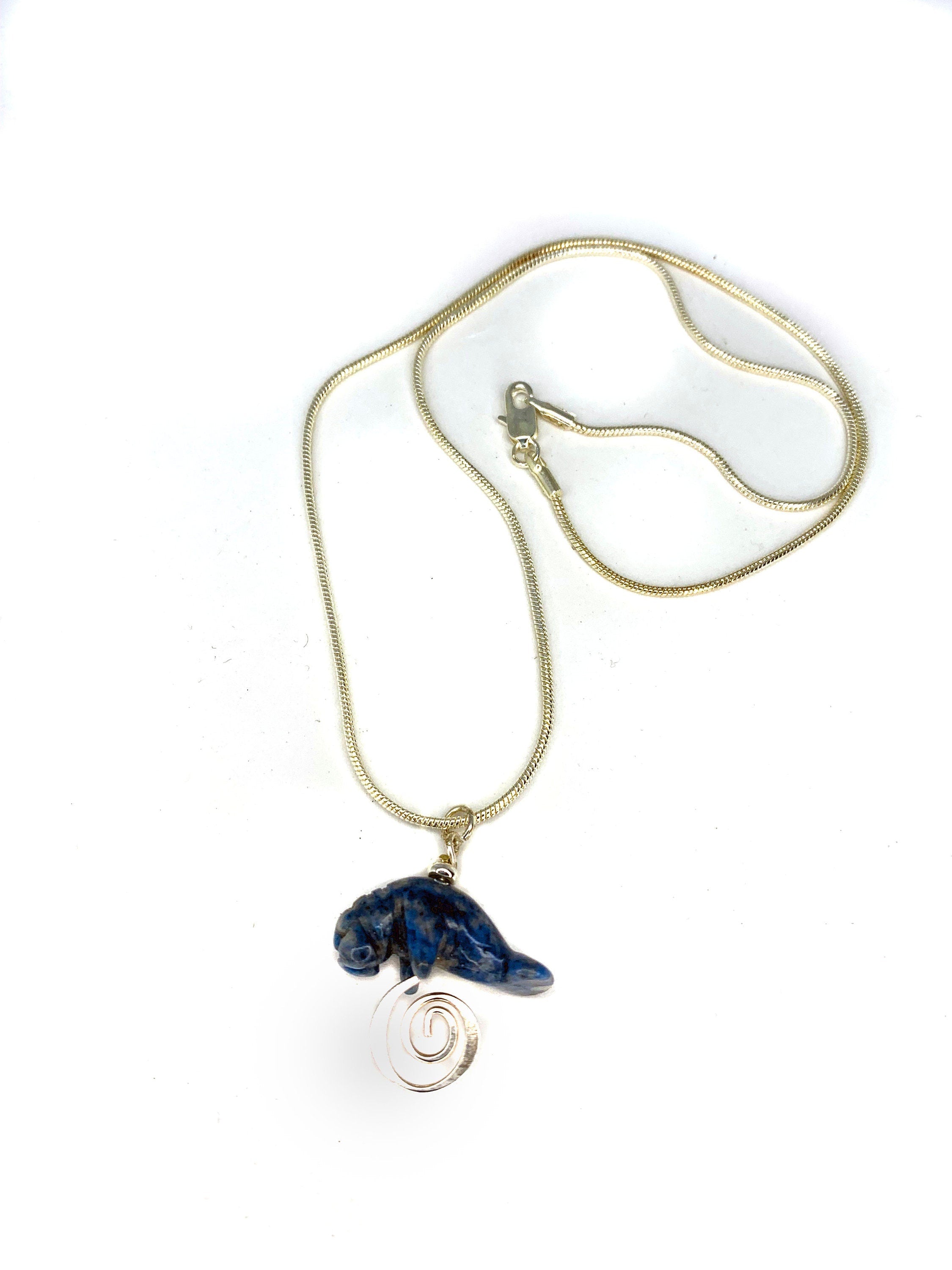 Manatee Blue Necklace featuring a carved stone sodalite pendant on a silver snake chain, perfect for beach lovers and animal gift enthusiasts.