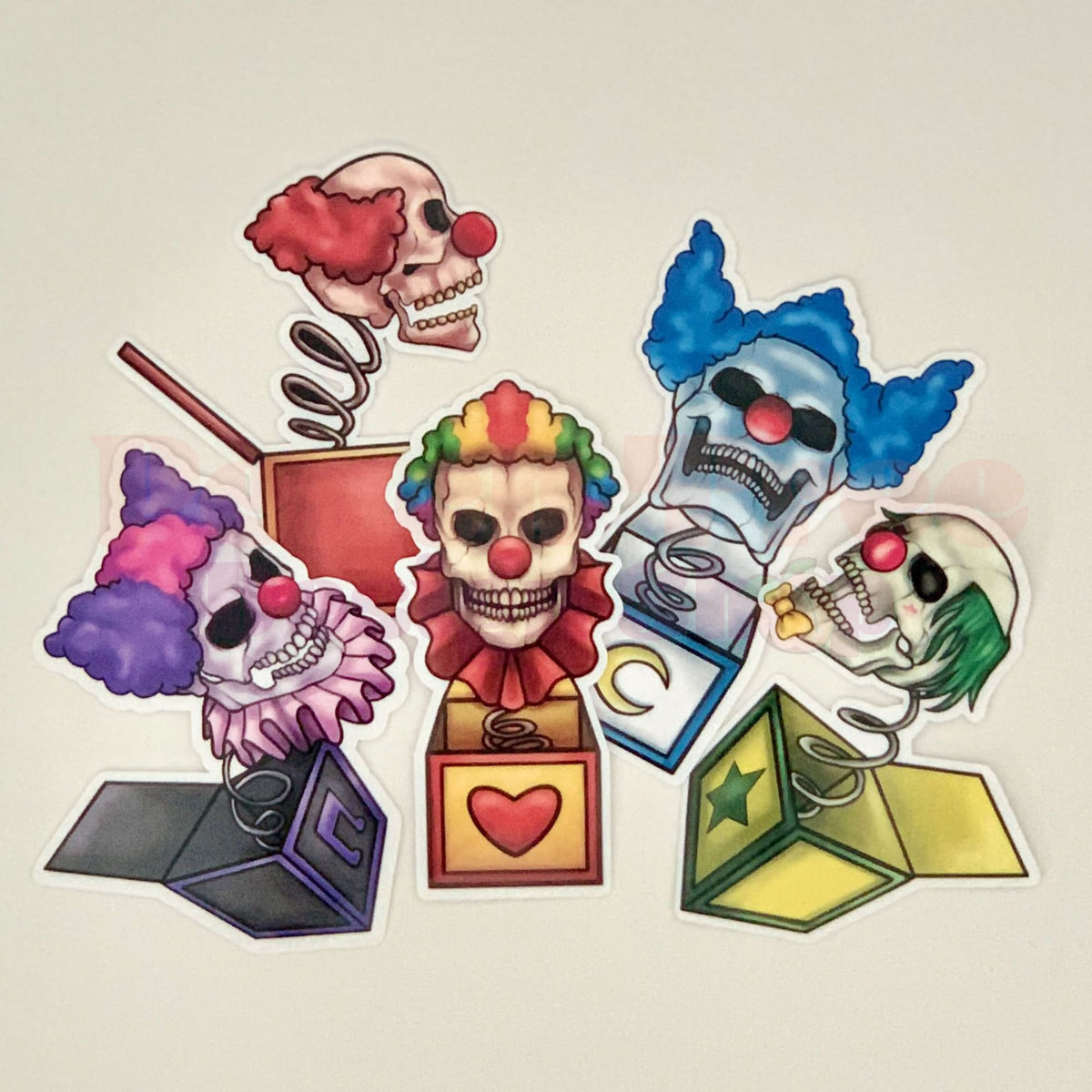 A set of various creepy clown-themed stickers, including skulls, skeletons, and colorful boxes, intended for Halloween decoration.