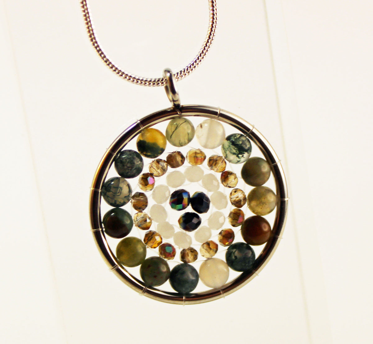 Artisan-crafted Mandala Pendant necklace with a silver medalion and zen aesthetics, combining beauty and tranquility.