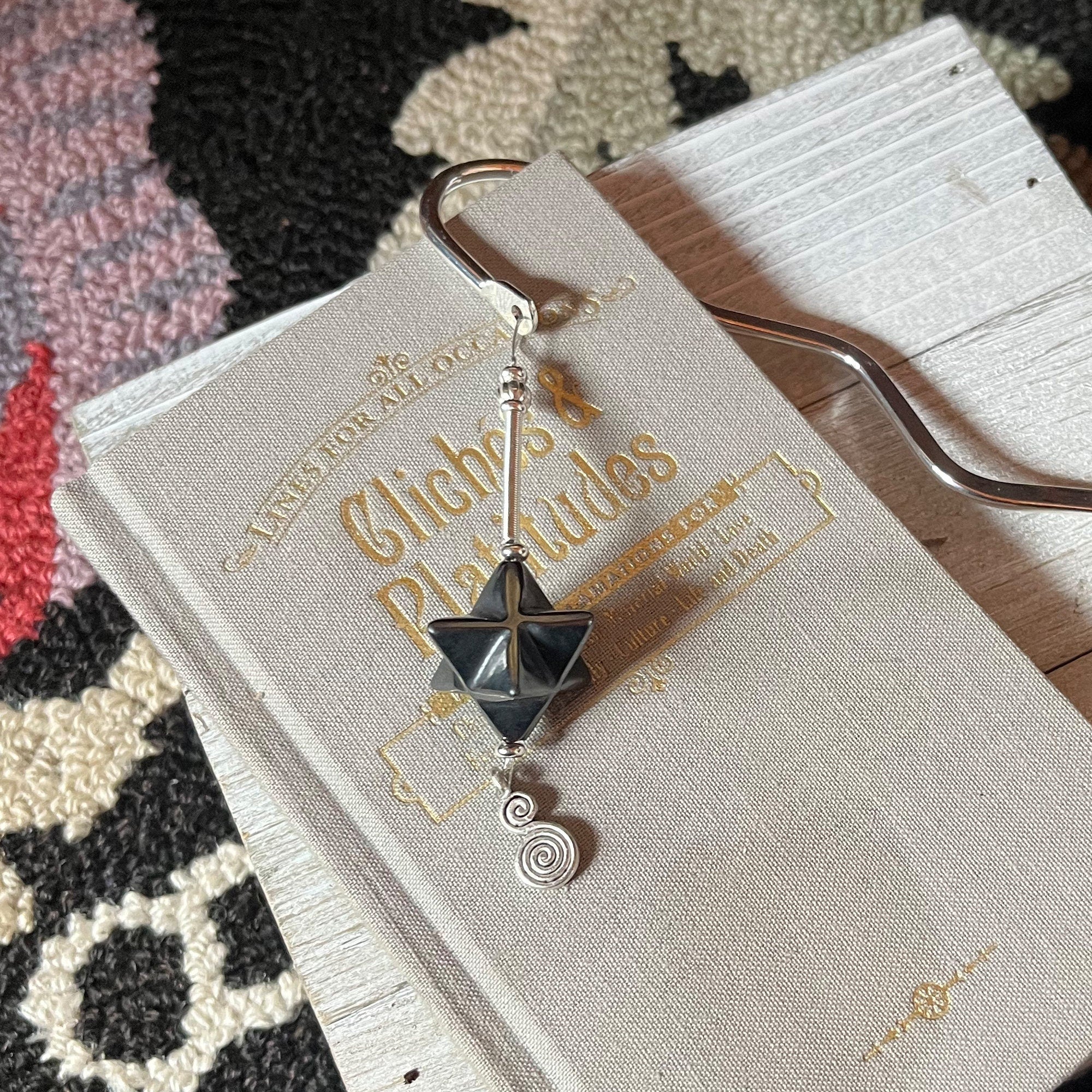 Detailed view of Sacred Geometry Merkaba Bookmark with Hematite showcasing intricately carved silver spine, perfect for meditation and spiritual reflection.