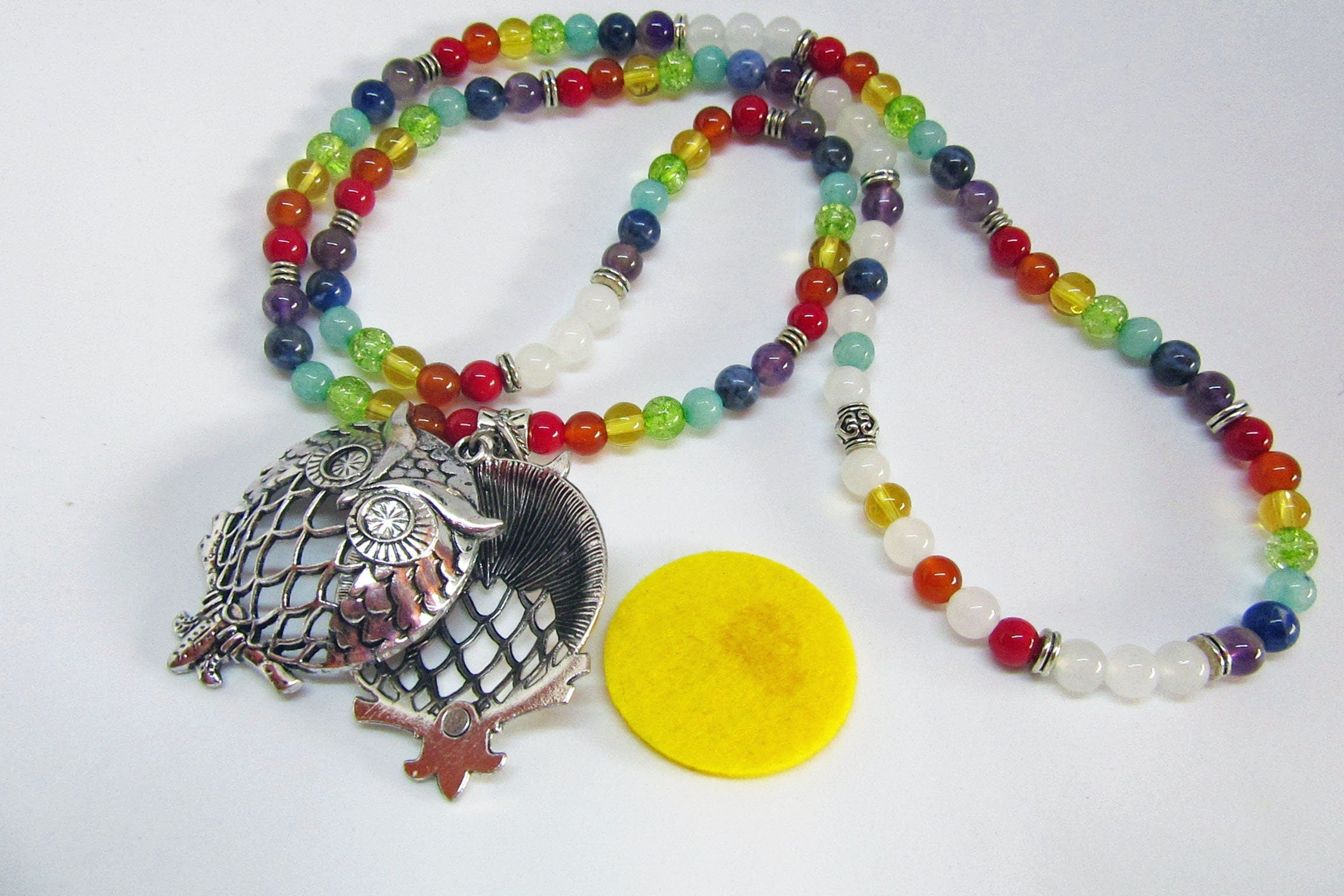 Aromatherapy Jewelry for Zen and Relaxation - Rainbow Quartz Mala Essential Oil Diffuser Necklace worn on a model, highlighting its length and style.