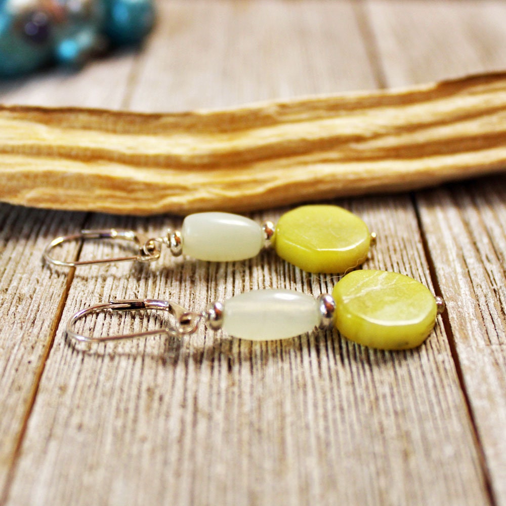 Aventurine & Quartz Hexagon Earrings—sterling silver with sacred geometry, featuring yellow-green and milky white stones, displayed on rustic wood beside driftwood.