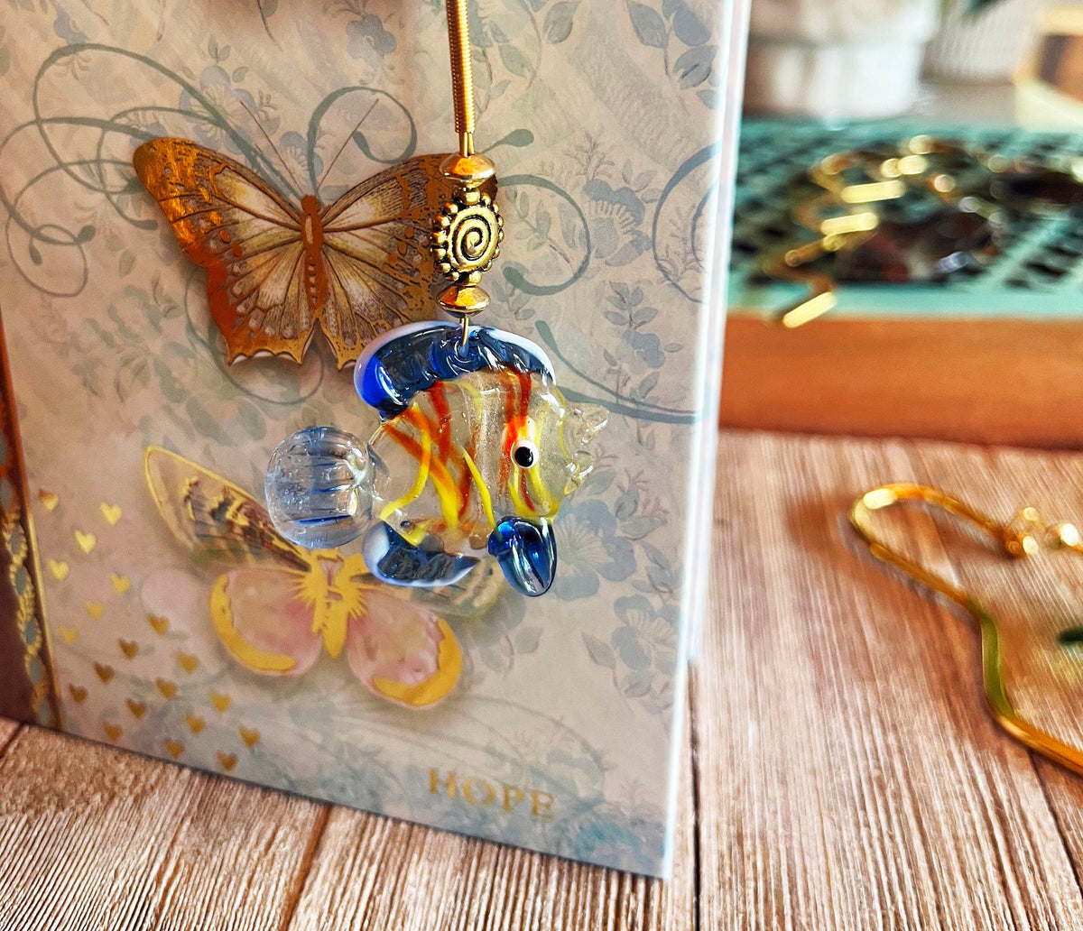 Gold Metal Bookmark featuring a vibrant Glass Fish charm, perfect aquatic page holder gift for aquarists.