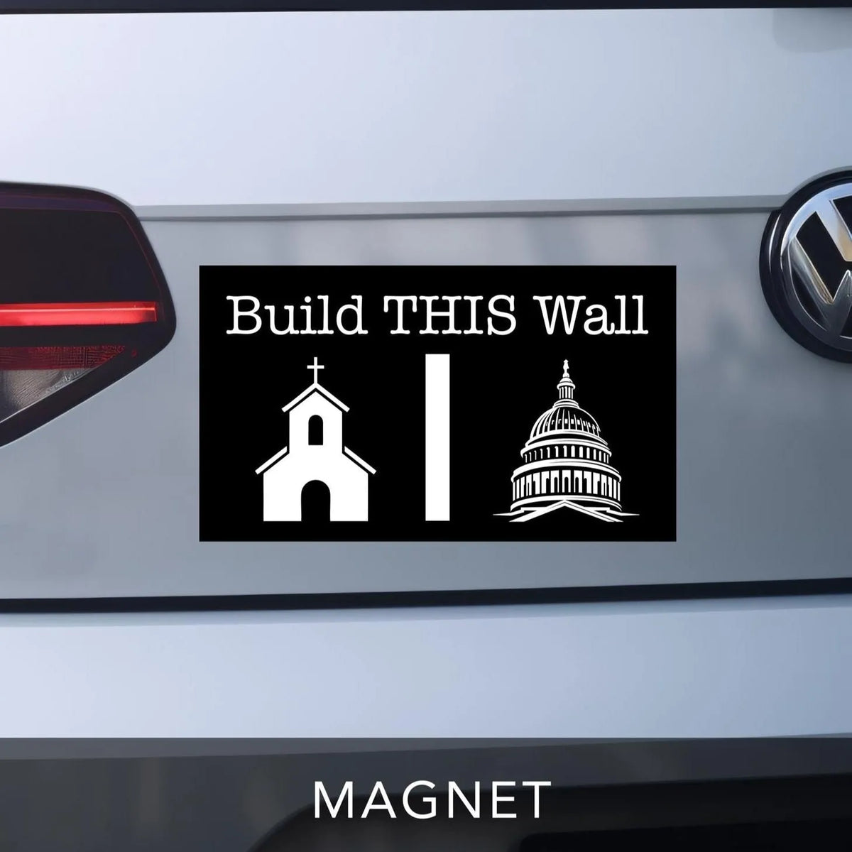 Build THIS Wall Car bumper magnet. Black with white lettering and graphics. Church graphic on left and government capitol building on right with a wall separating the two.