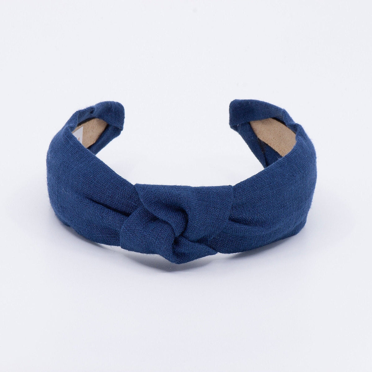 May include: A dark blue knotted headband made of fabric.