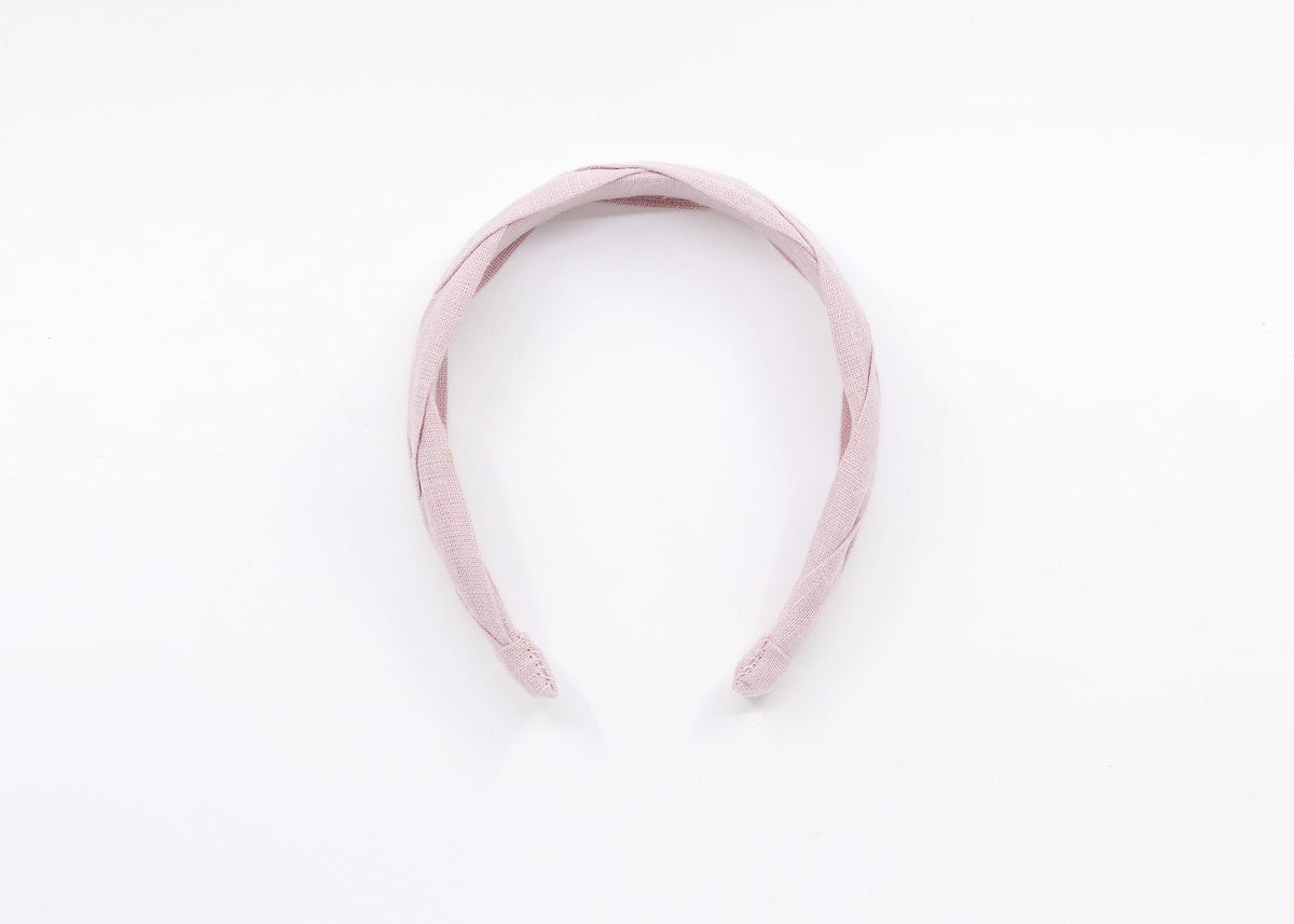 A light pink braided linen headband.