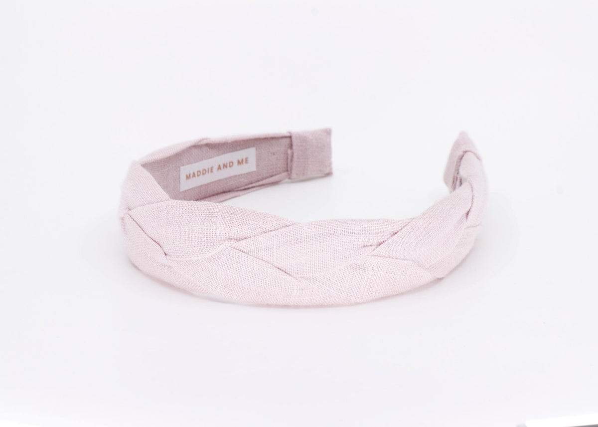A light tan braided linen headband. The headband has a label that says "MADDIE AND ME".
