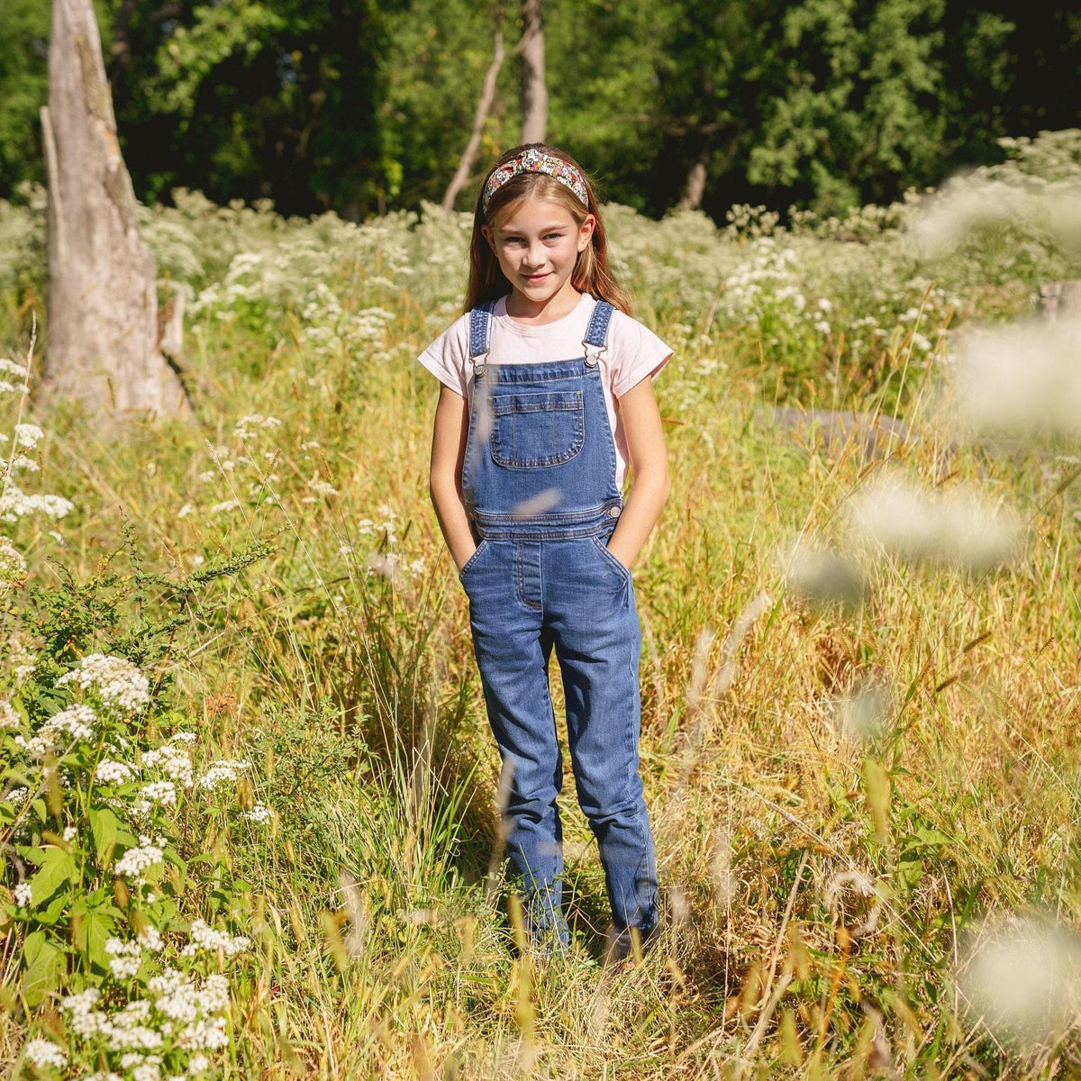 A girl wearing floral headband in outdoor setting