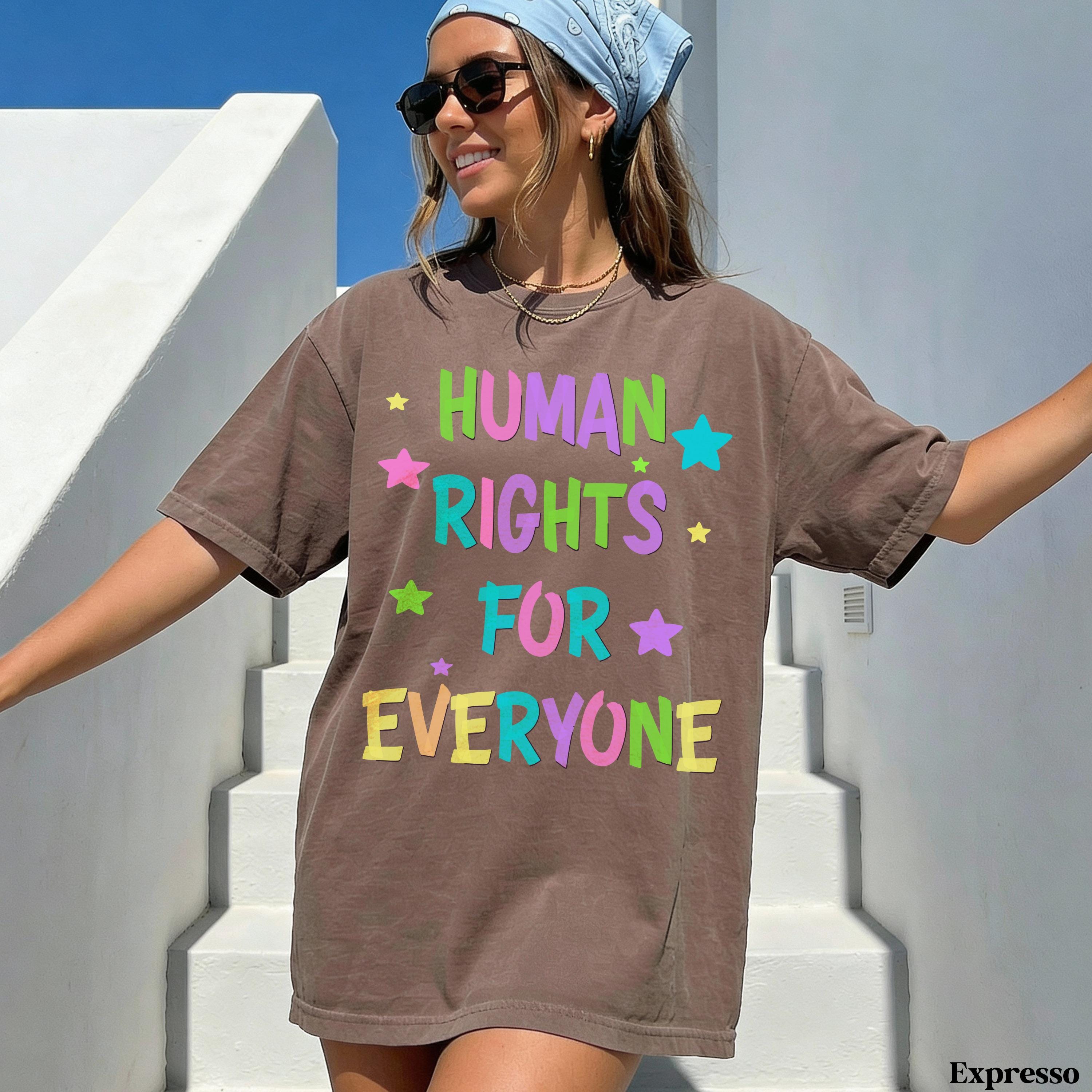 Brown t-shirt with "HUMAN RIGHTS FOR EVERYONE" text and colorful stars.