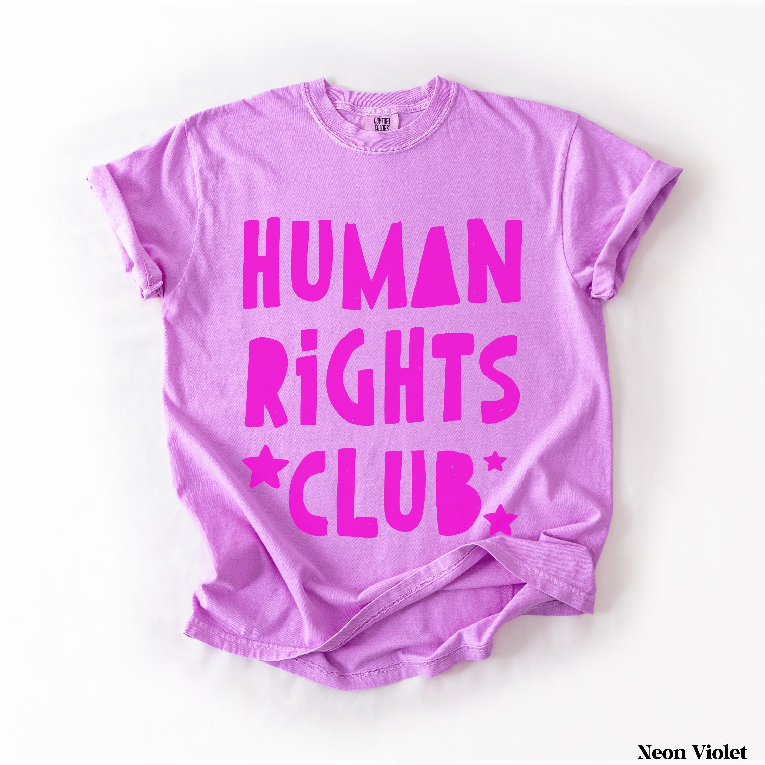 Purple t-shirt with "HUMAN RIGHTS CLUB" in pink text and star accents.