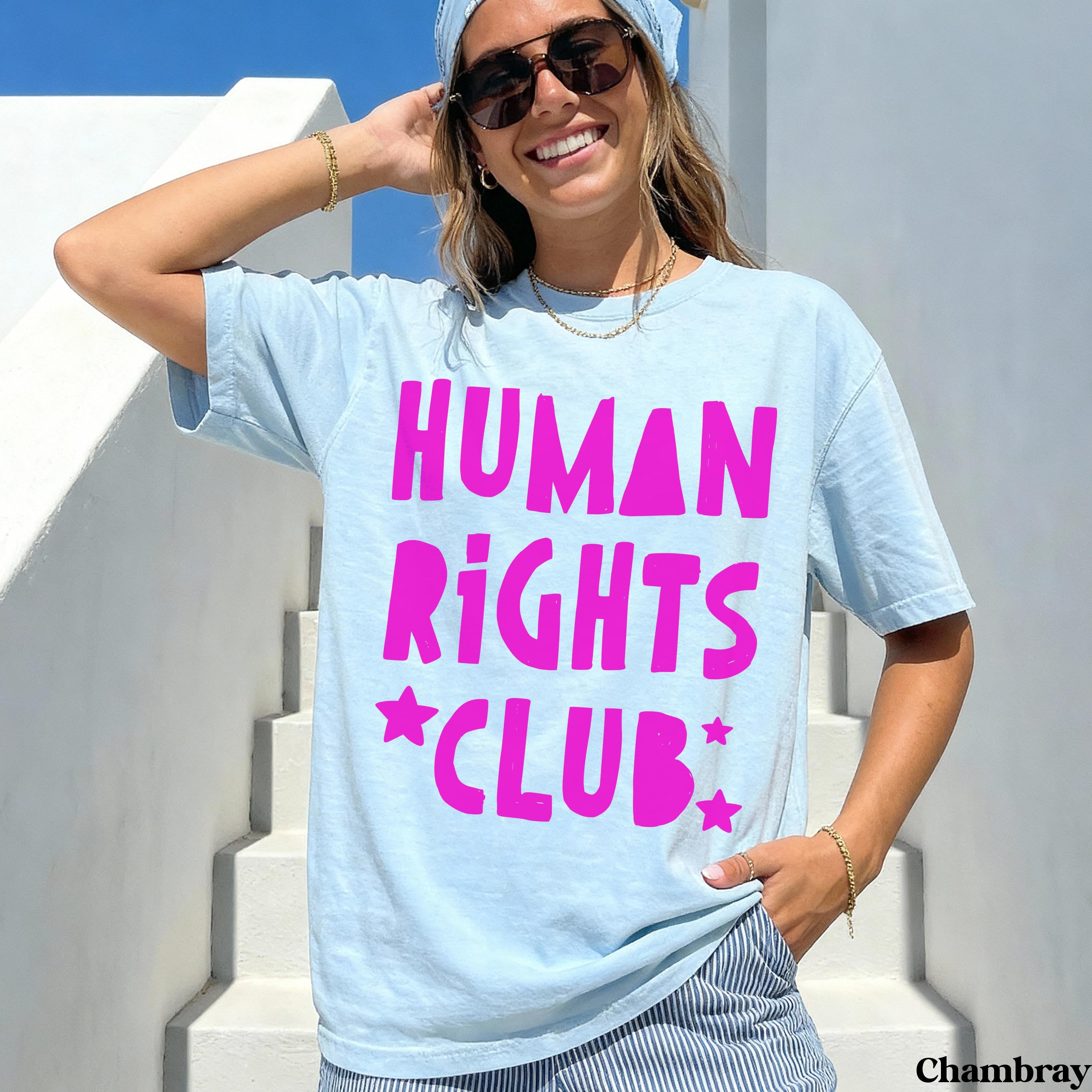 Light blue t-shirt with "Human Rights Club" and stars printed in hot pink.
