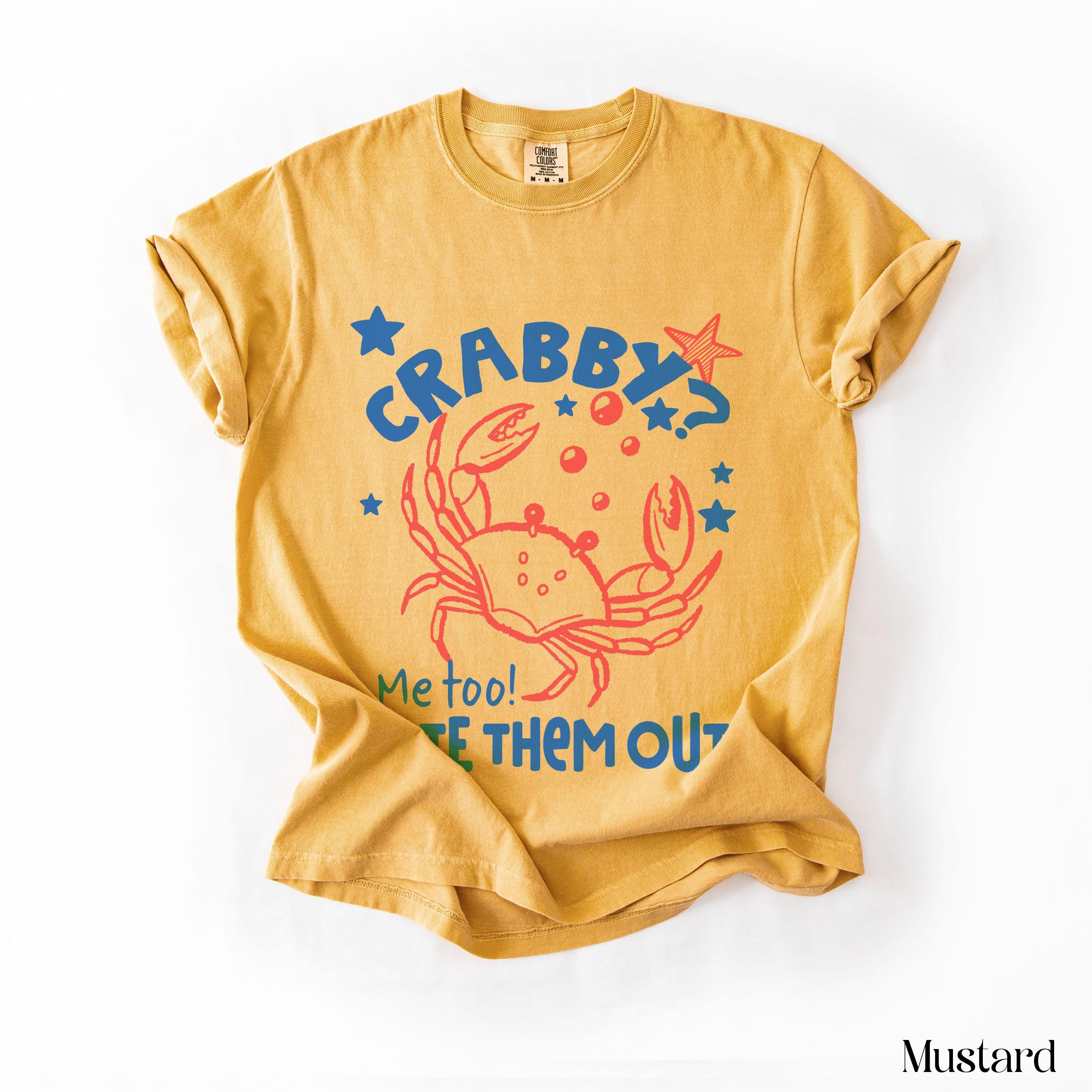 Mustard t-shirt with red crab graphic saying "CRABBY? Me too! LET THEM OUT!".