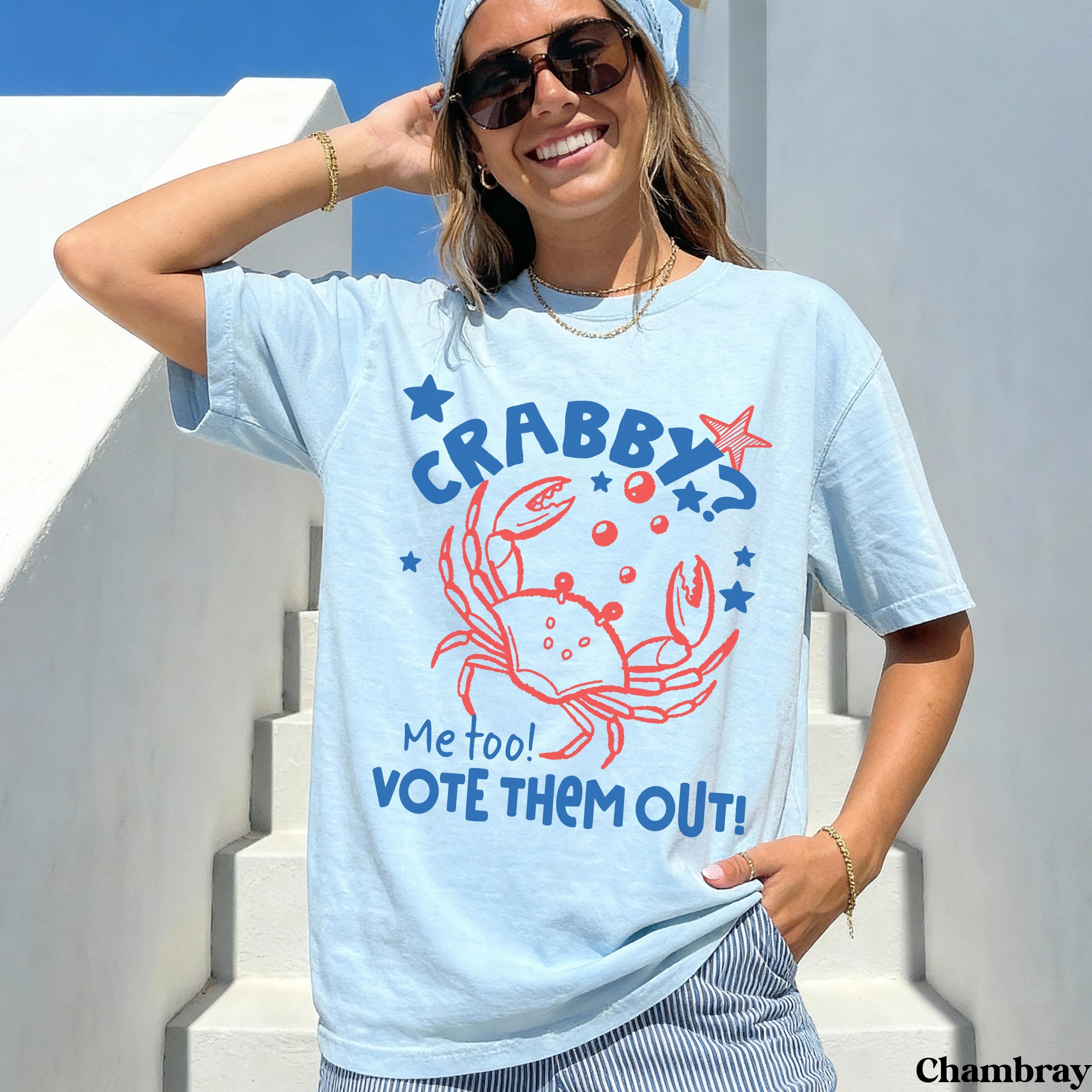 Light blue t-shirt with a red crab graphic and "Crabby? Vote them out!" text.