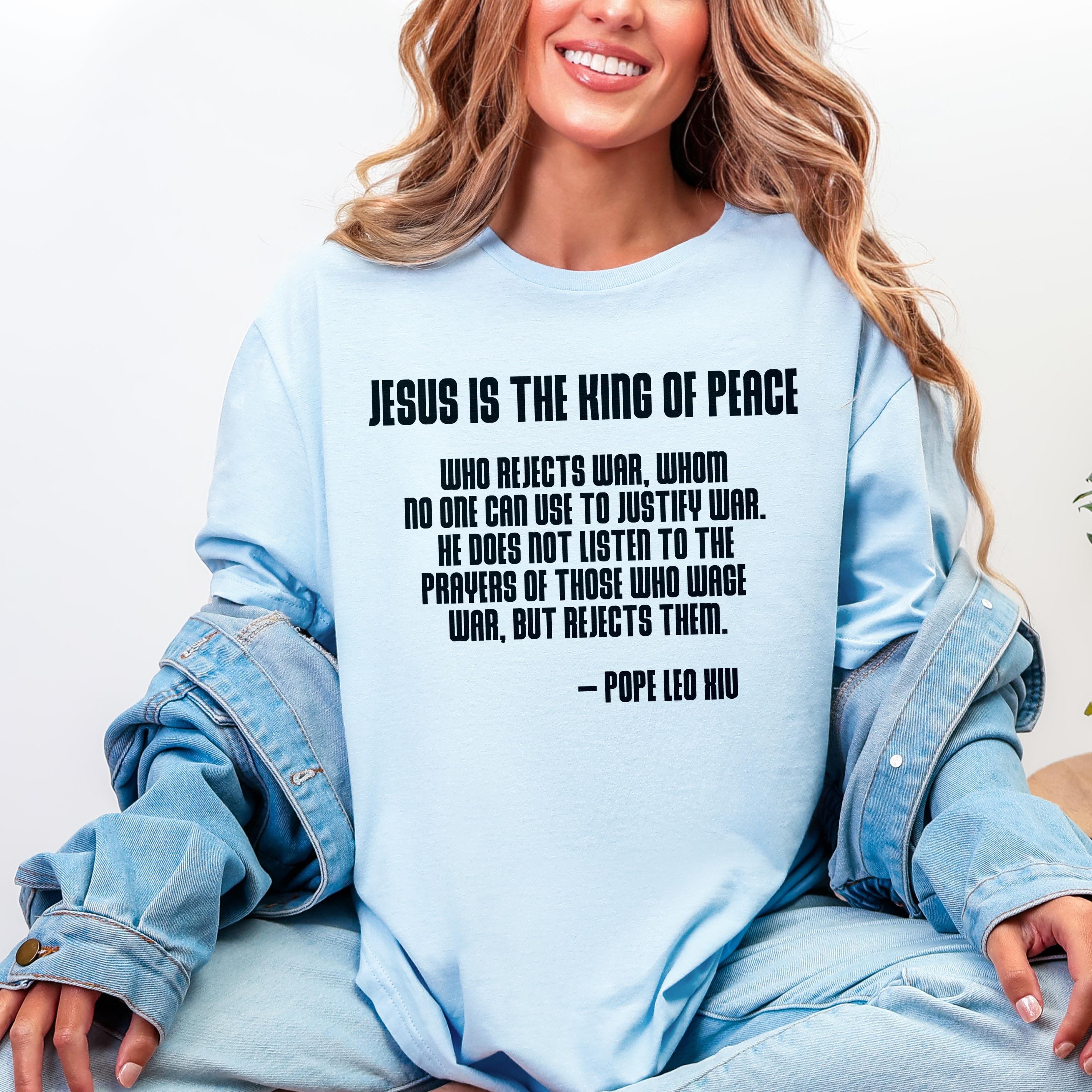 Light blue t-shirt with quote from Pope Leo XIU about Jesus and war.