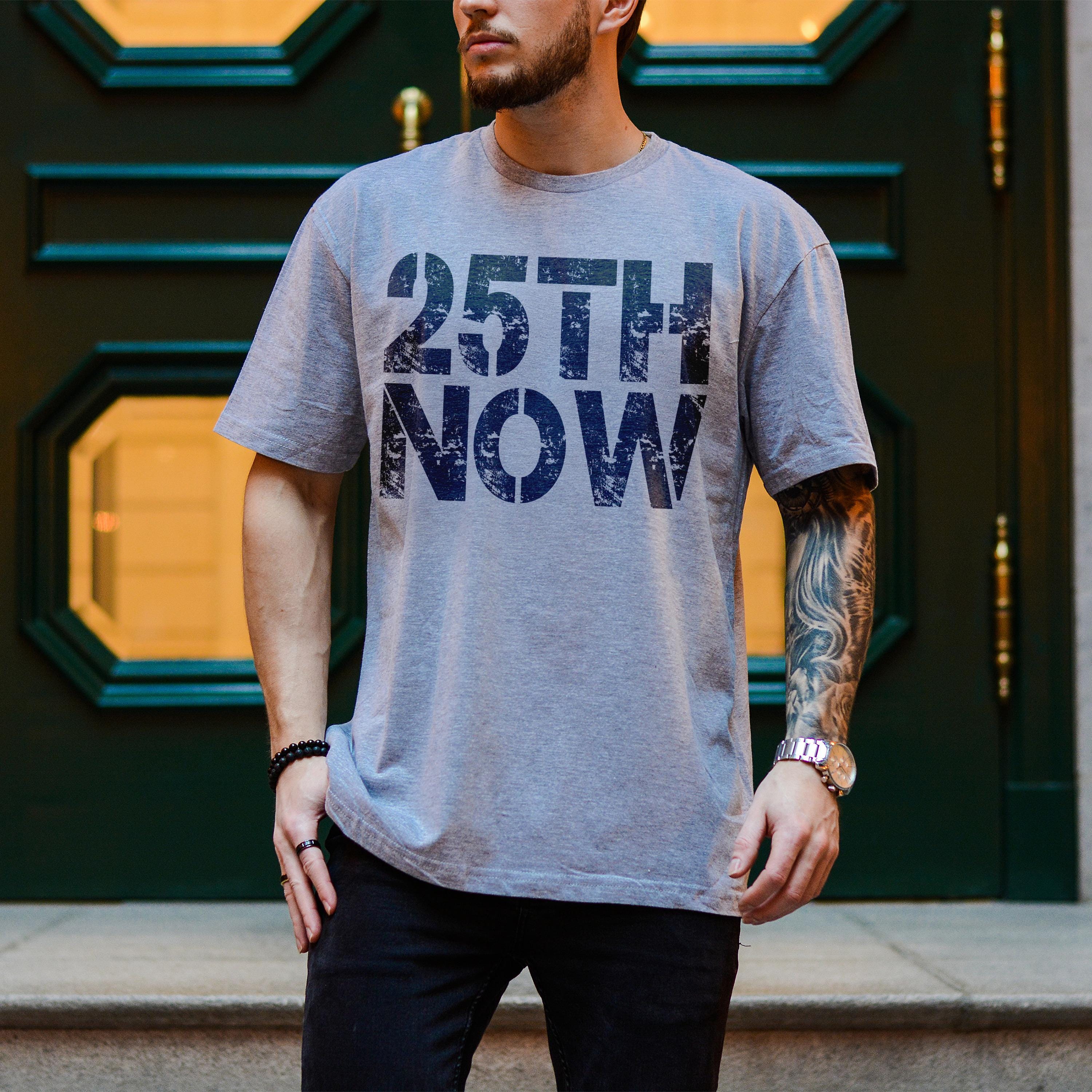 Grey t-shirt with "25TH NOW" text on the chest.