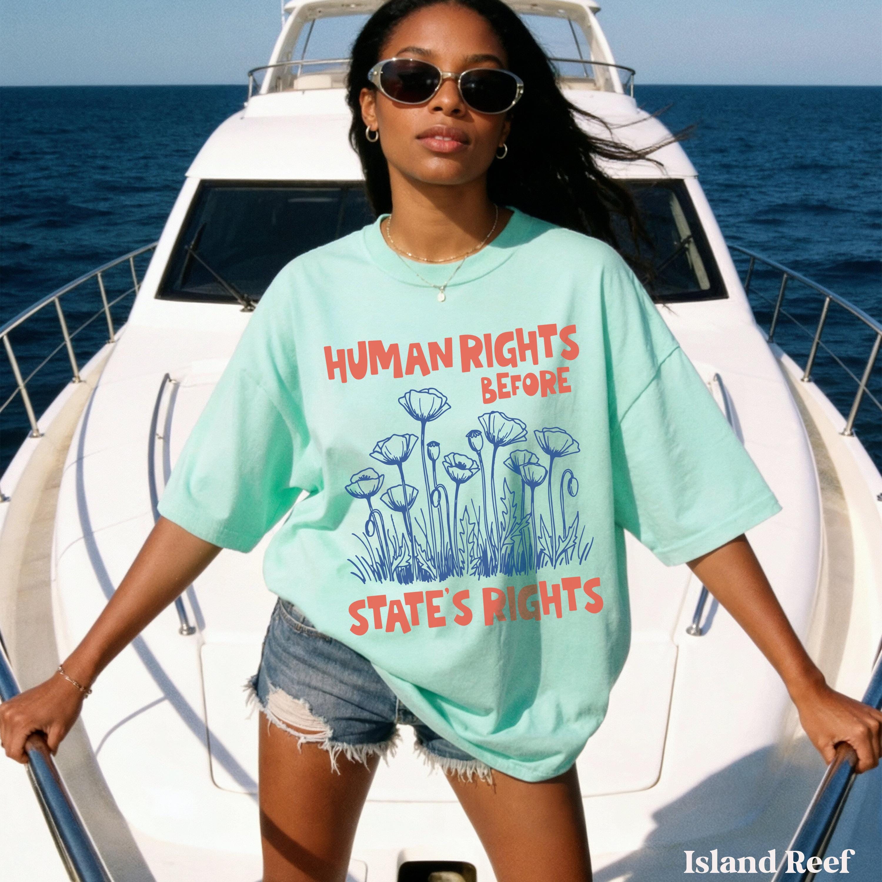 Woman in mint t-shirt with "HUMAN RIGHTS BEFORE STATE&